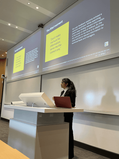 A view from an airplane window shows the aircraft's wing with a golden hue reflecting the setting sun, against a serene backdrop of fluffy clouds and a clear sky.