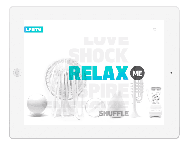 A tablet screen displays a white background with the text "LOVE SHOCK" partially obscured by "RELAX" in teal. Below it, "SHUFFLE" is written in gray. Various white objects, including a fan, sphere, fan blades, blender, trumpet, and ball, are arranged around the text. A small black circle labeled "ME" appears to the right of the word "RELAX." The top left corner shows "LFNTV" in teal.
