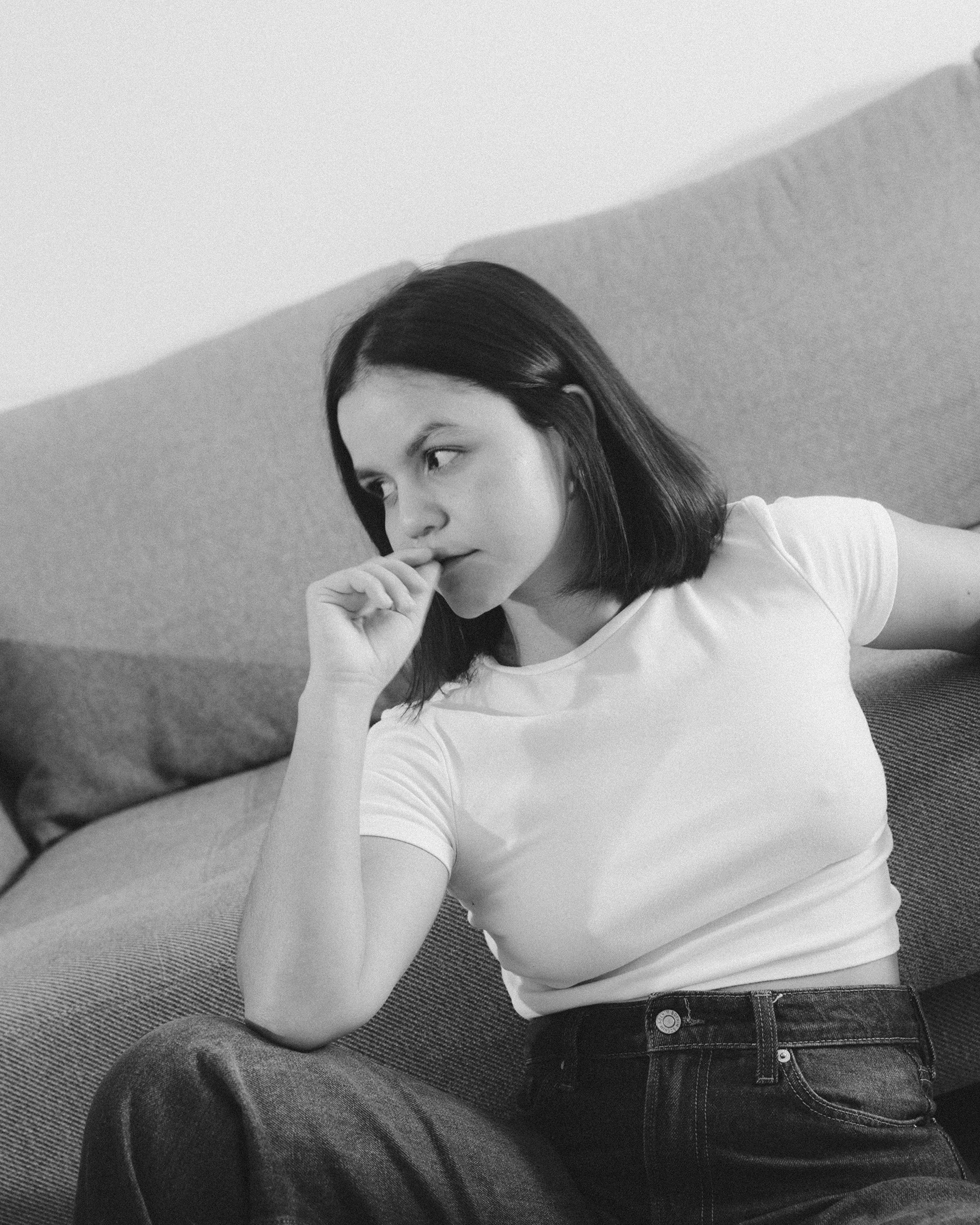 A view of a studio interior with modern decor, featuring large windows that offer a glimpse of lush greenery outside