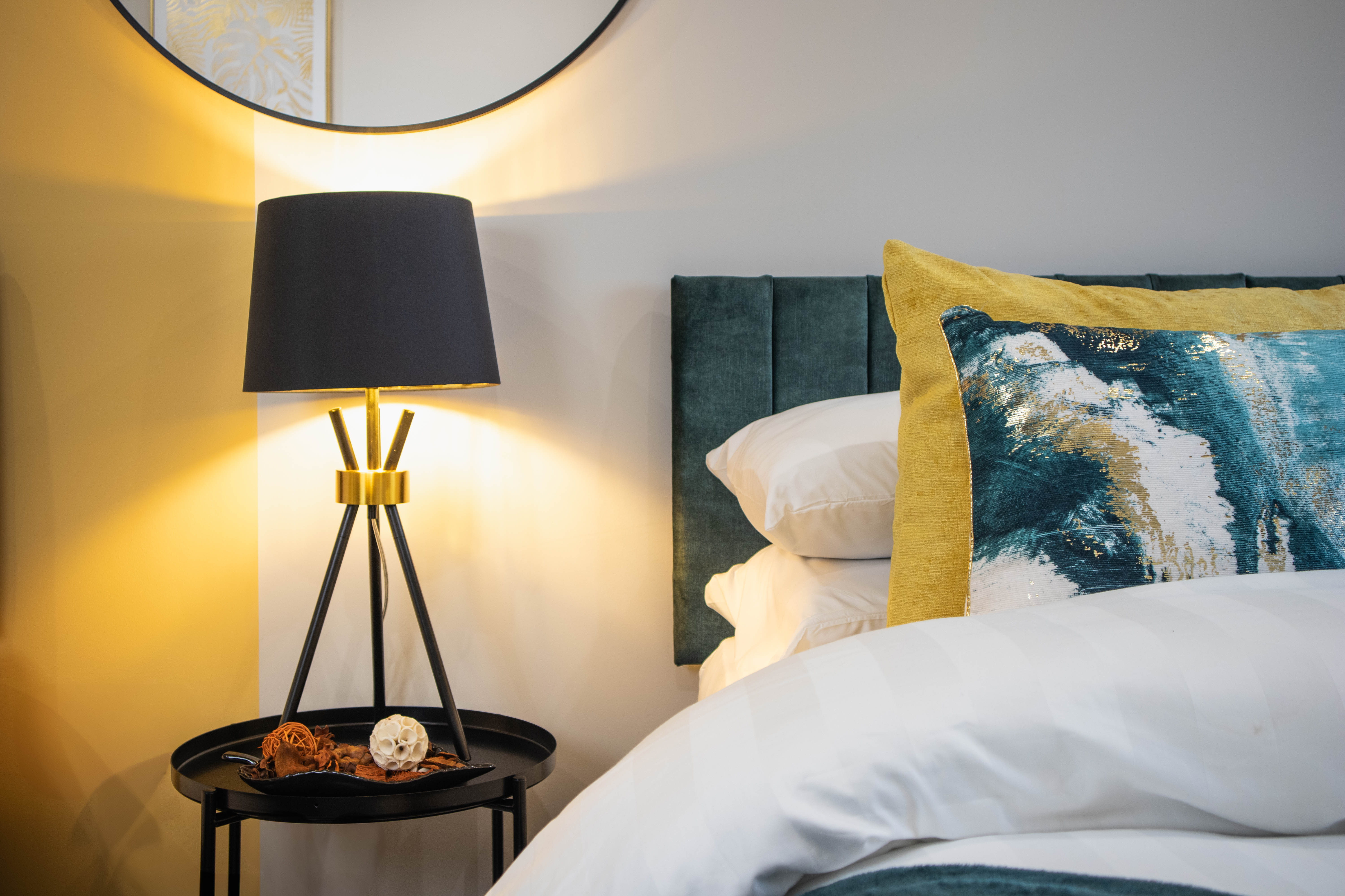 Green and golden Airbnb bedroom with large comfy bed