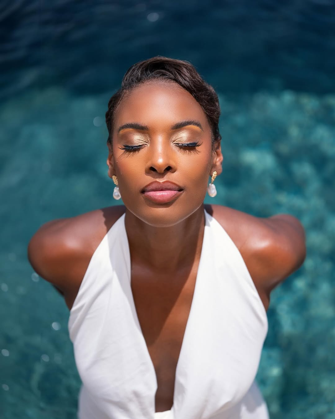 woman with white dress in front of a pool