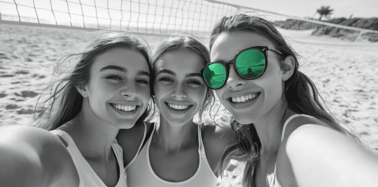 Three smiling people taking a selfie outdoors.
