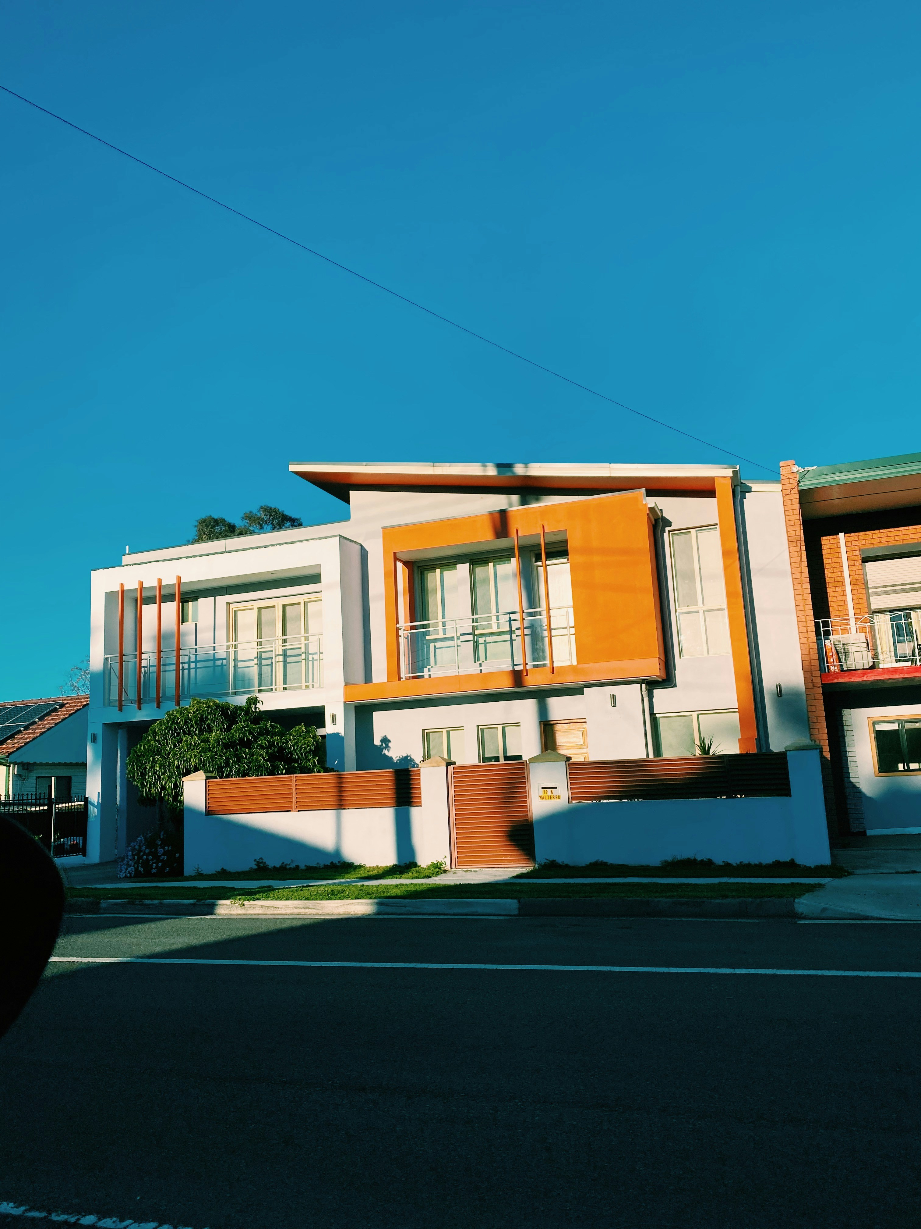 white and brown concrete house under blue sky during daytime