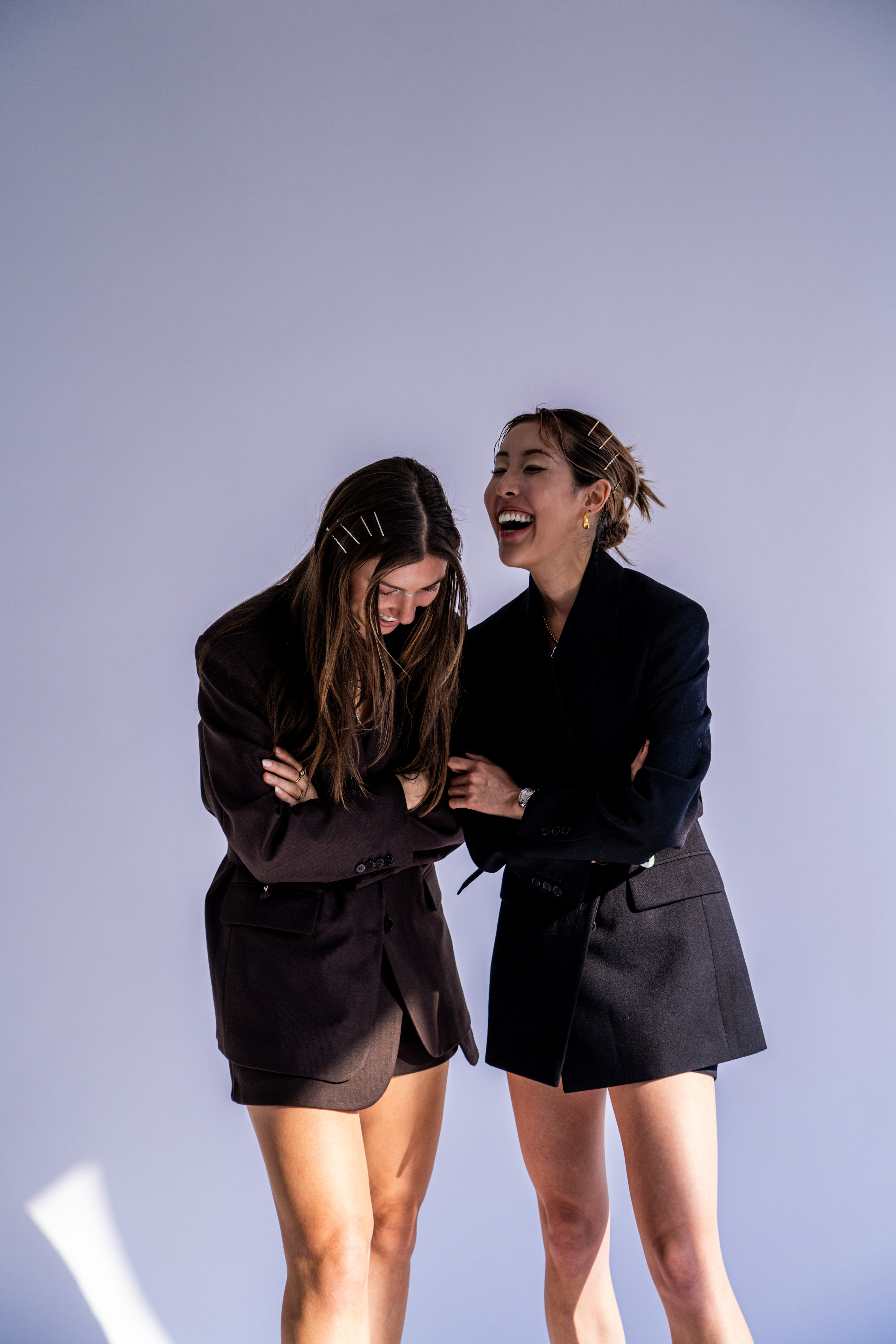 Women in streetwear sitting on leather couch