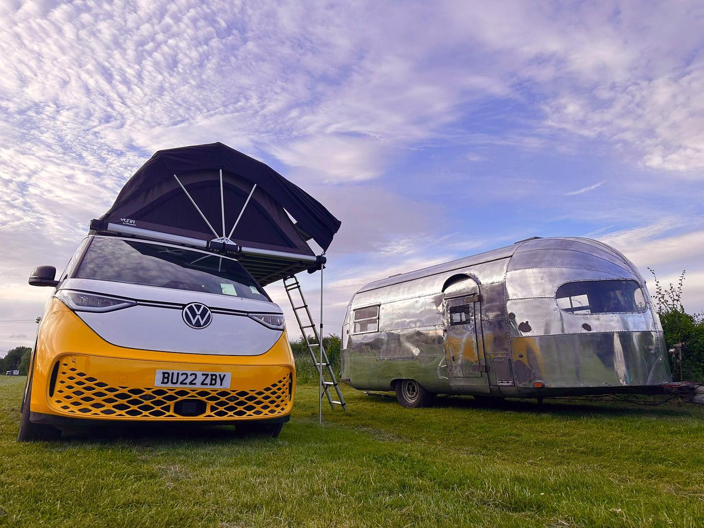 An Electric Volkswagen Camper With A Rooftop Tent