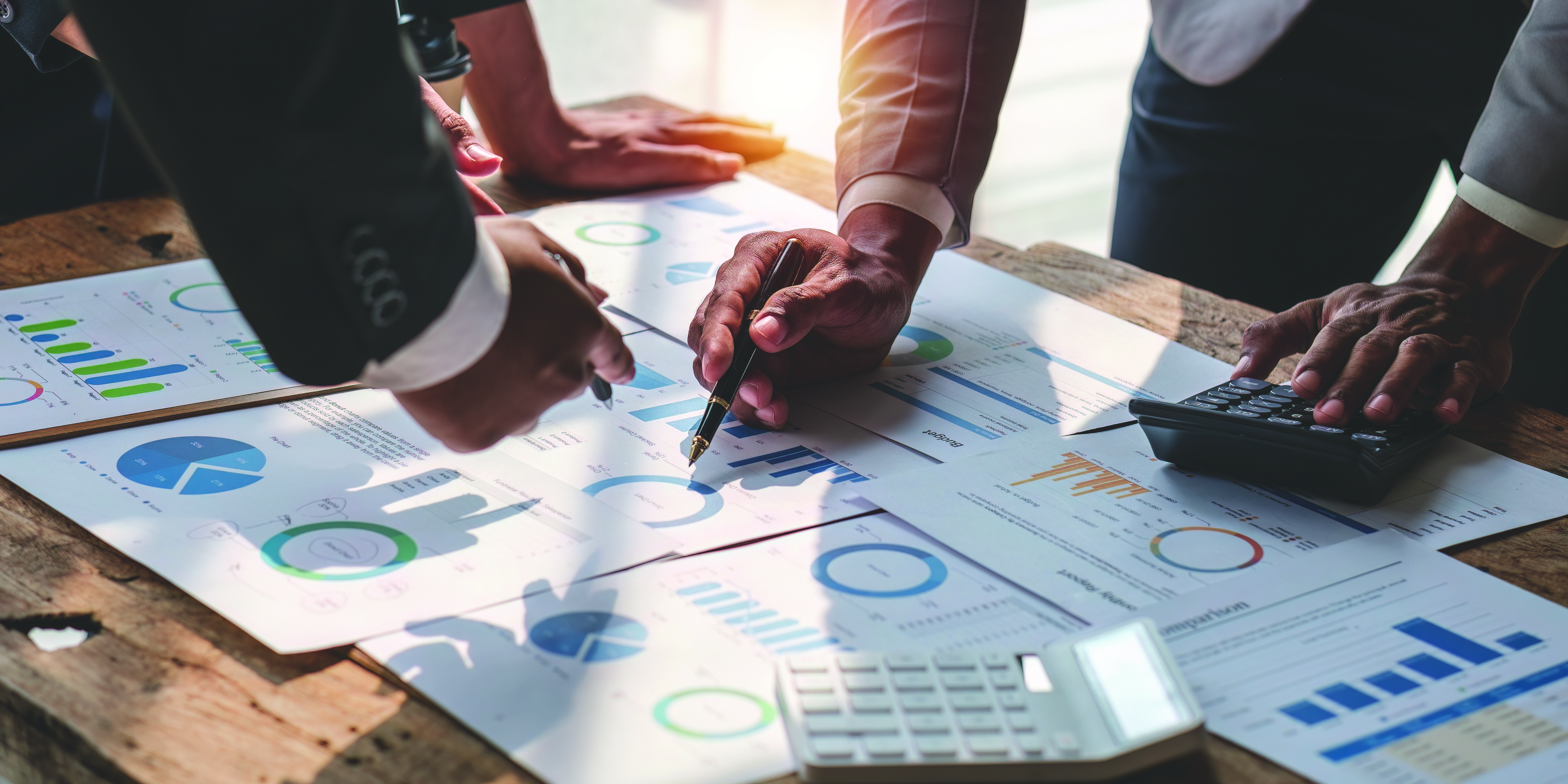 Business people reviewing financial charts and data