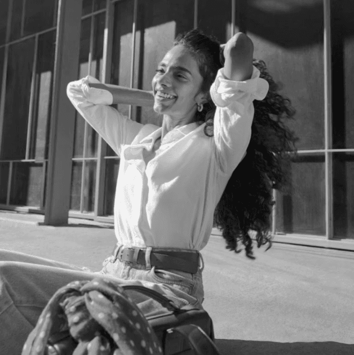 Woman working at desk with laptop and phone.