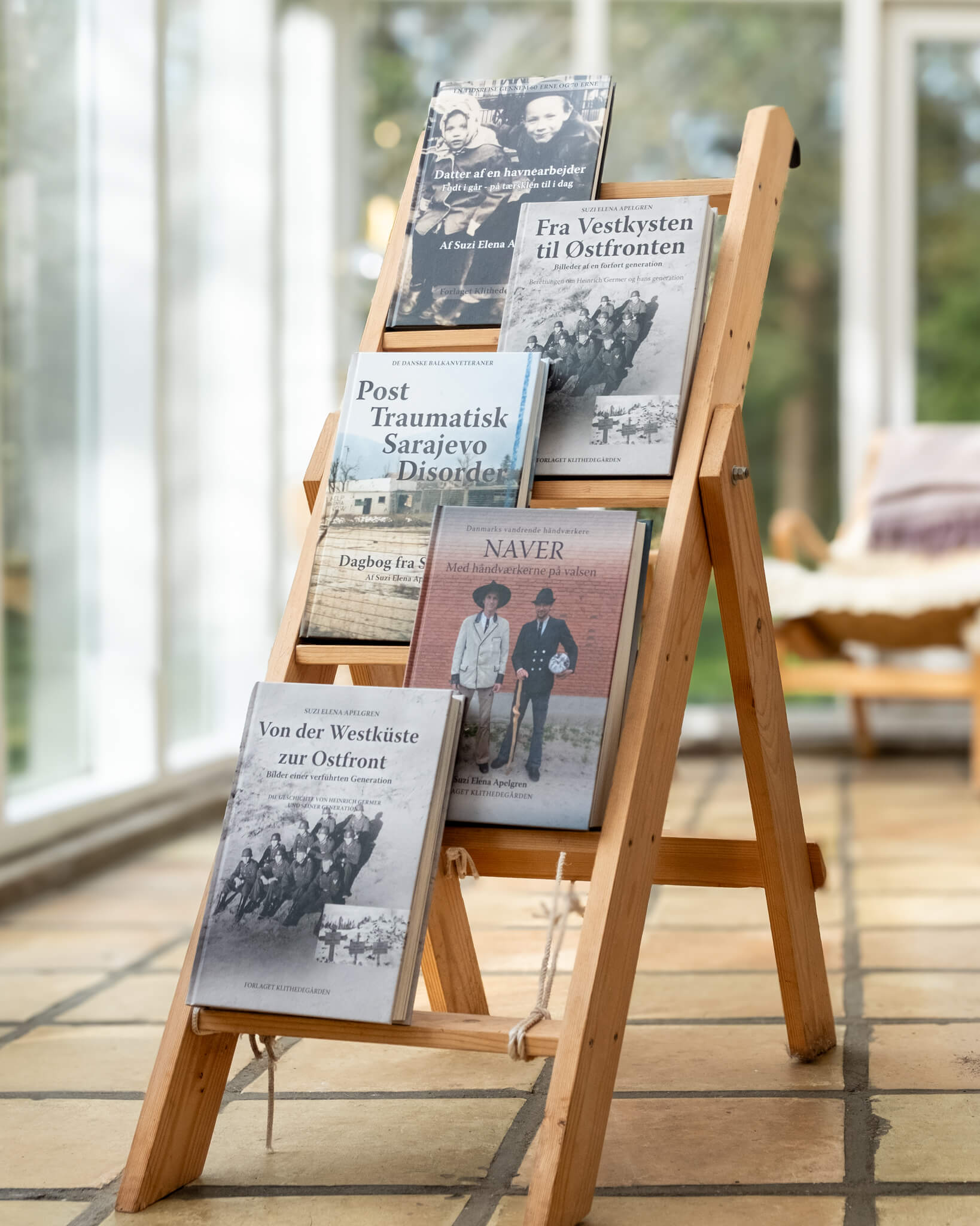 A stand with books written by Suzi, in an orangerie