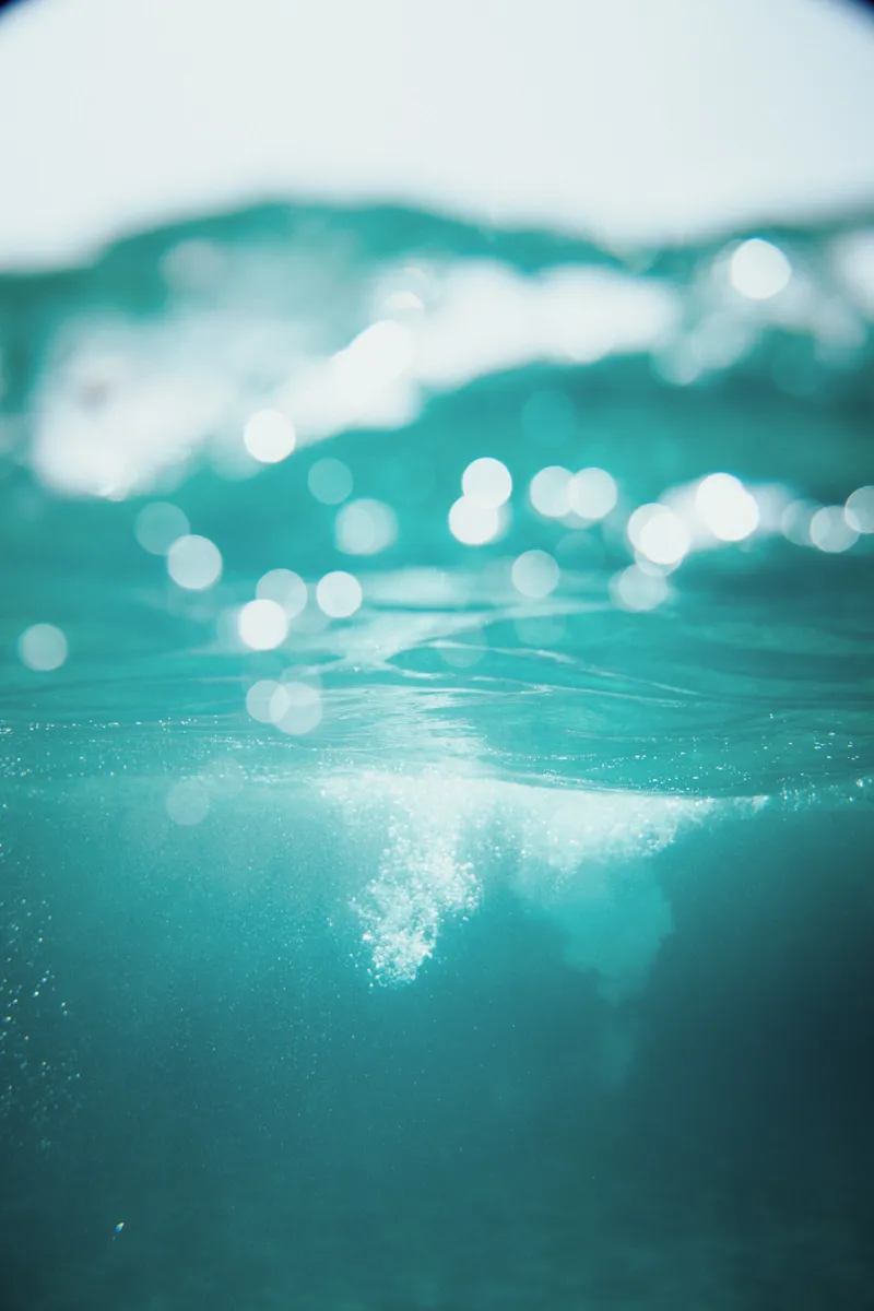 Underwater turquoise ocean bokeh — booking protection and quality kitesurf teaching guarantee — Explora Watersports Tarifa