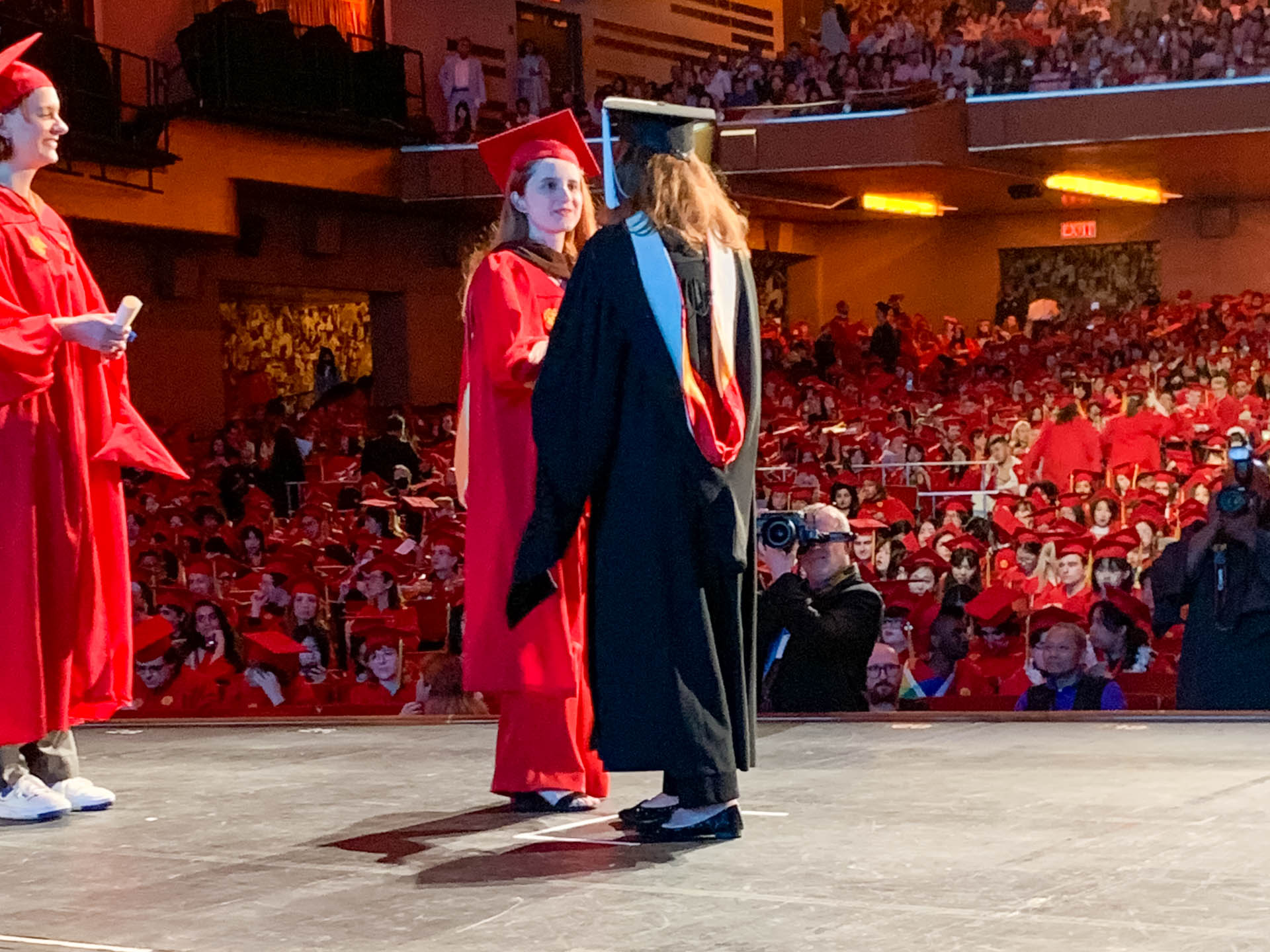 a student getting their diploma on stage