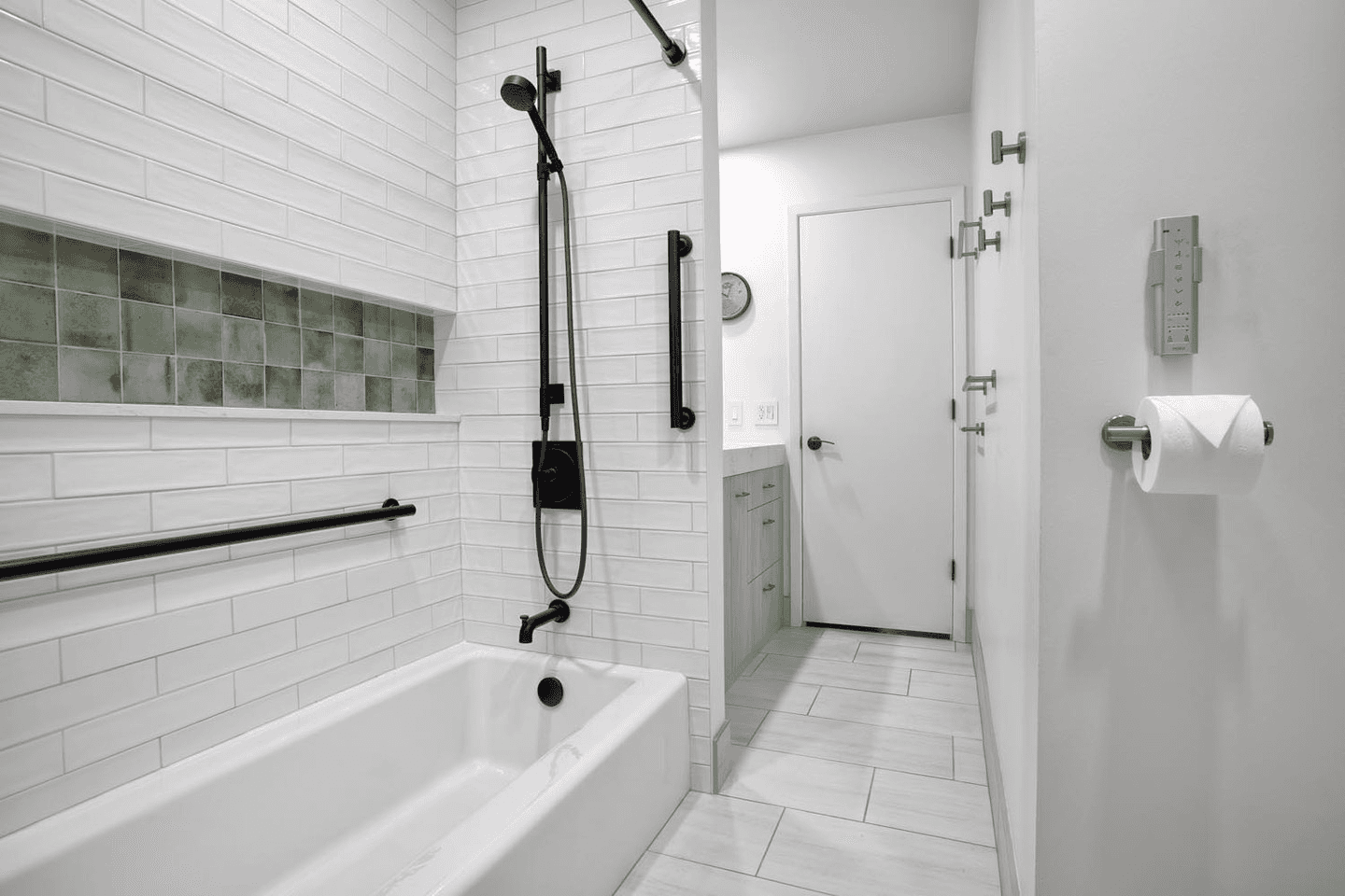 a bathroom with a tub, sink, and mirror