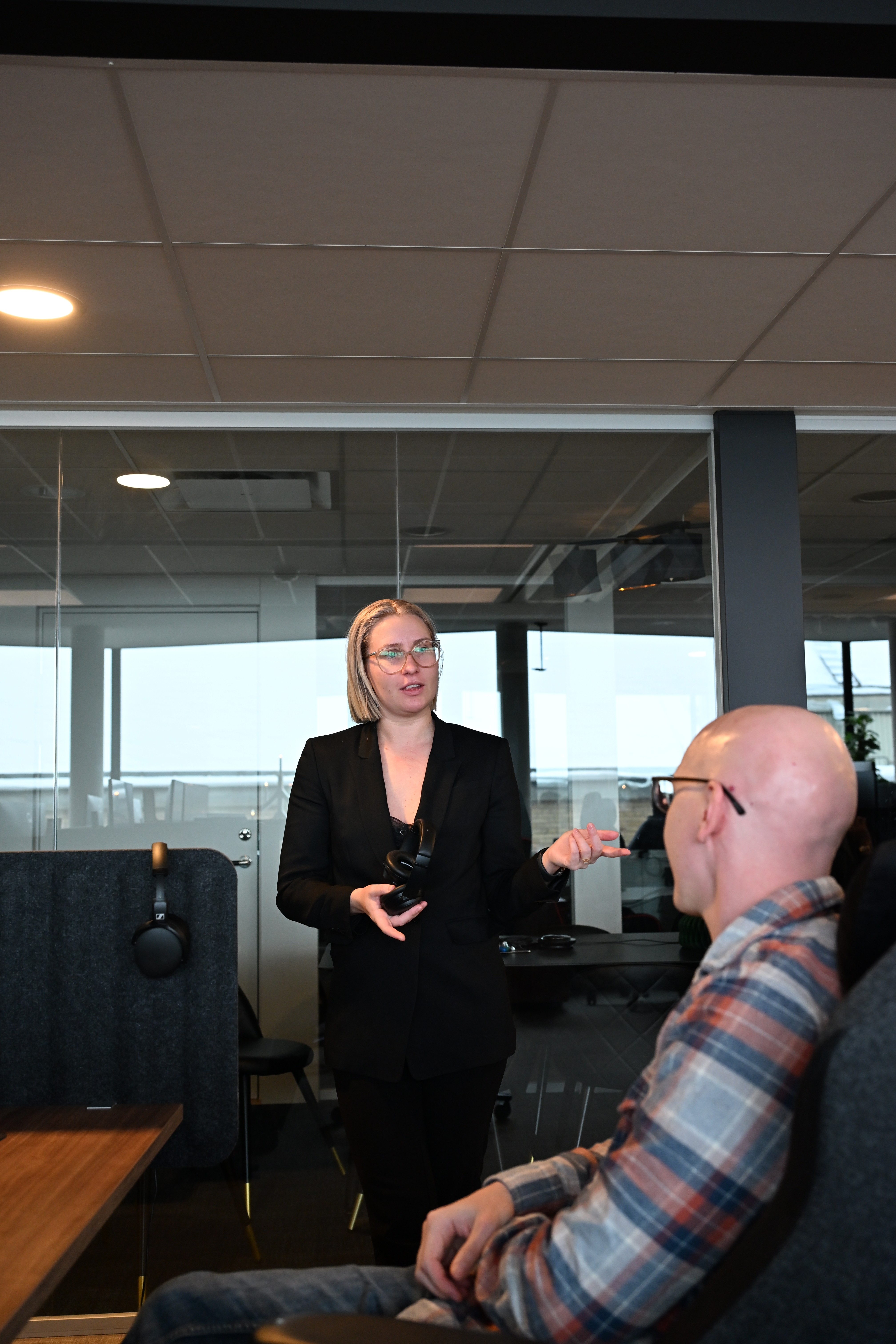 three people sitting in front of table laughing together