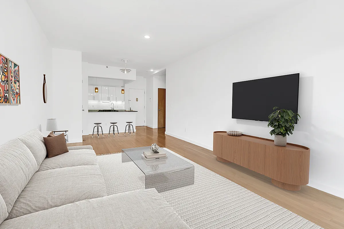 A cozy living room featuring a couch, coffee table, and television, creating a welcoming atmosphere for relaxation.
