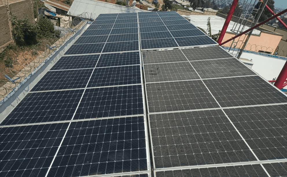 Aerial view of a winding road cutting through rocky terrain with patches of grass.