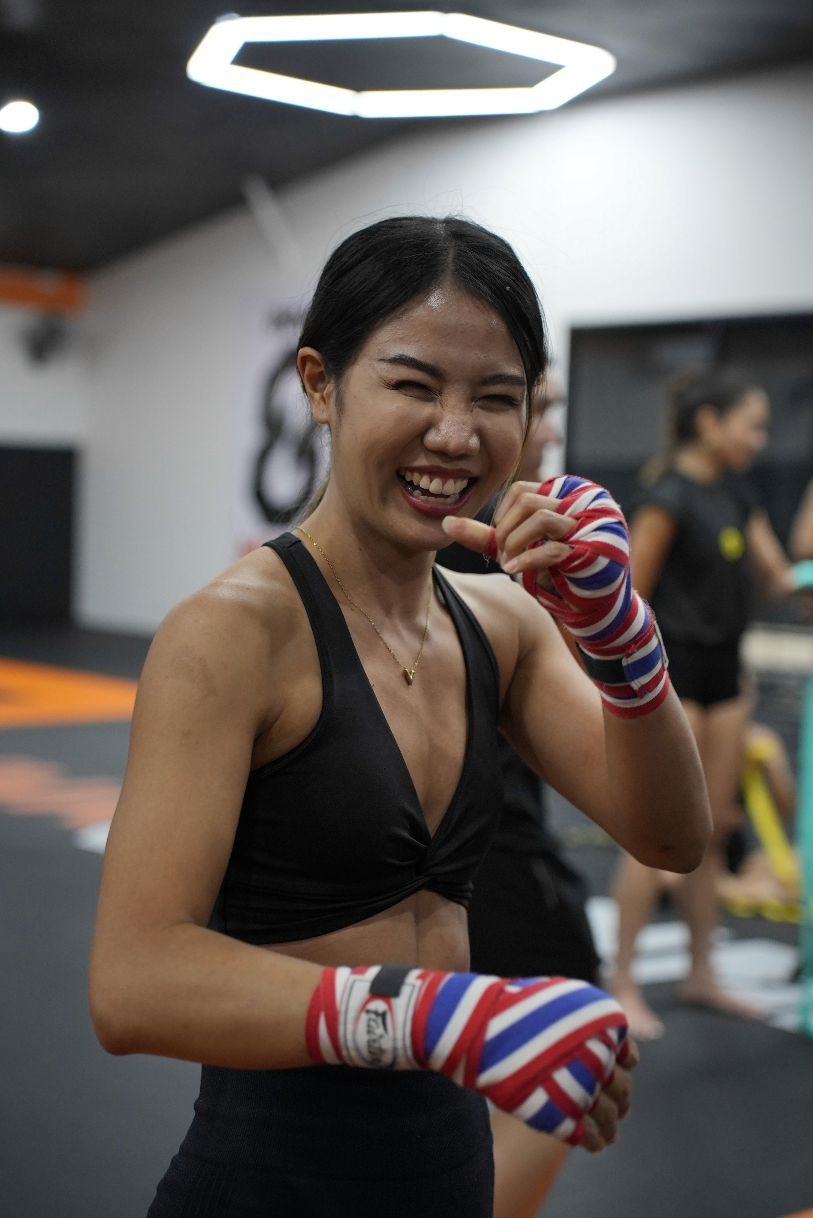 woman laughing and looking happy at INNOV8 MMA Gym