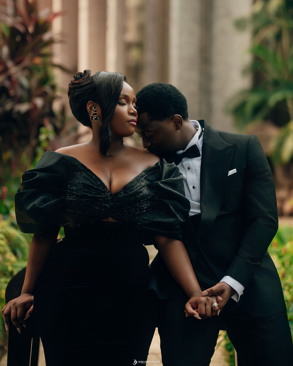 Close-up of a dark green leaf showing its textured surface and central vein against a muted background.