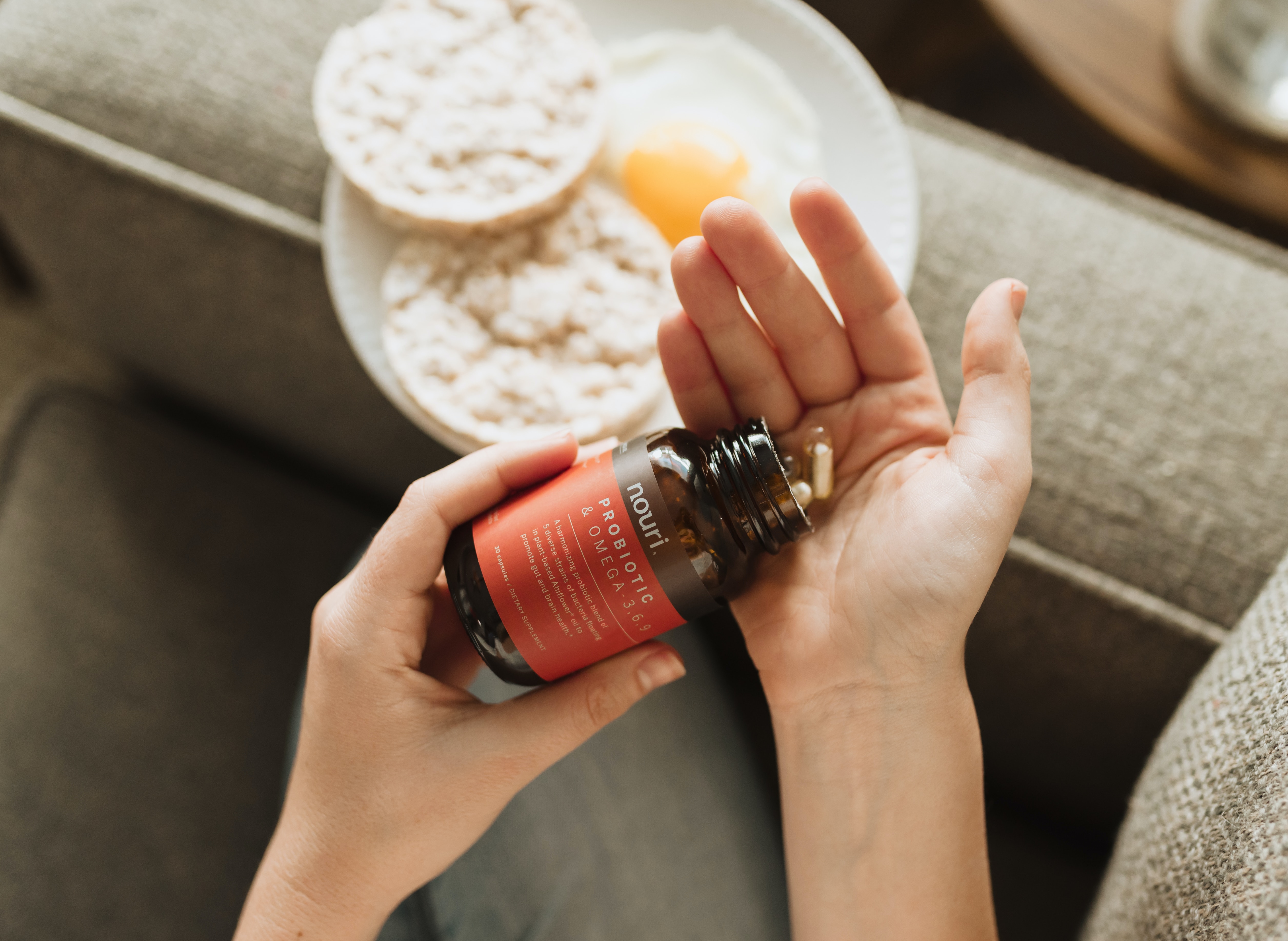 Woman pouring vitamins in her hand