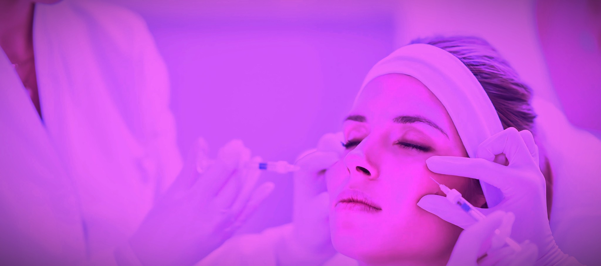 Aerial view of a dermatologist treating a patient with filler injections.