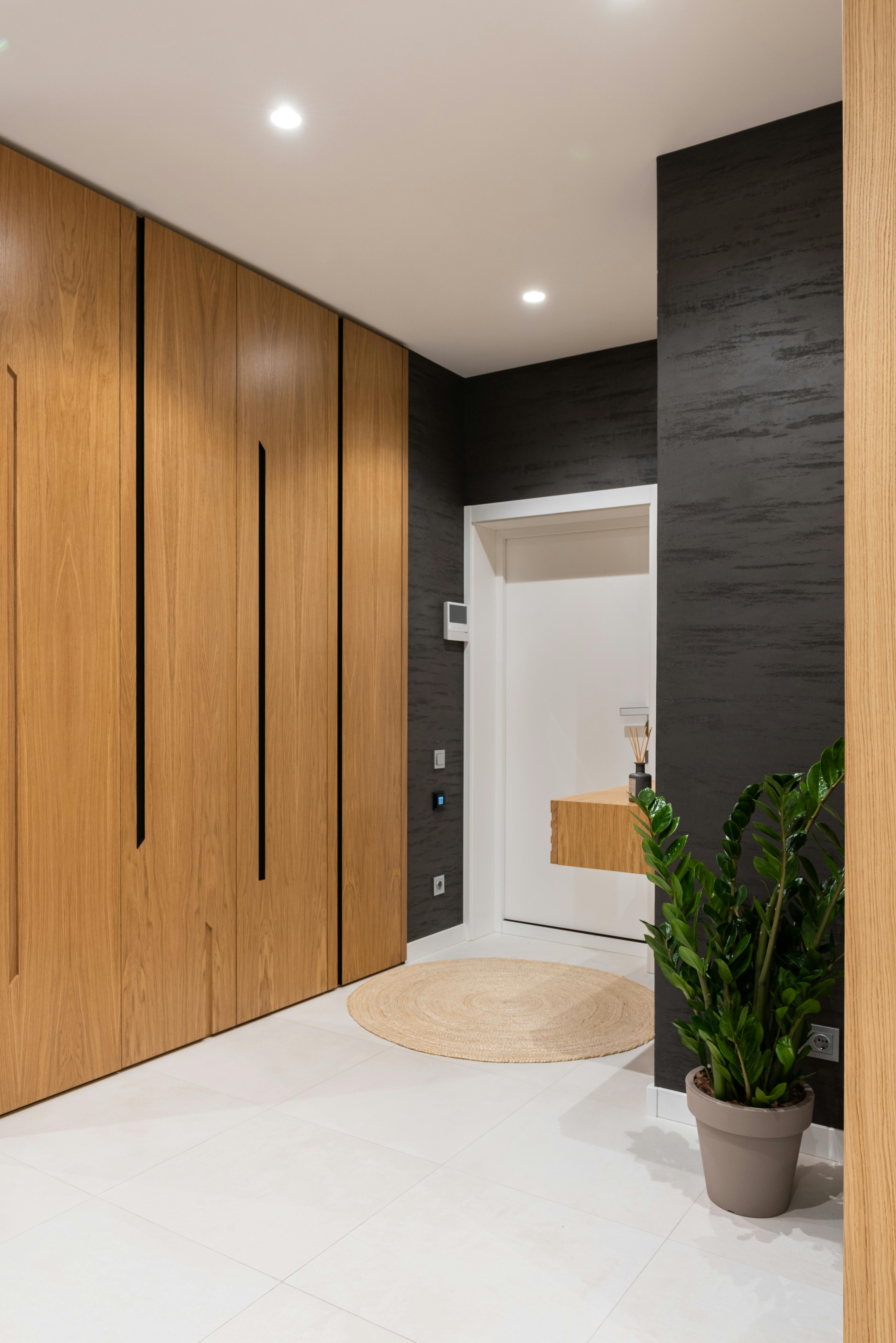 a room with a large wooden door and a window