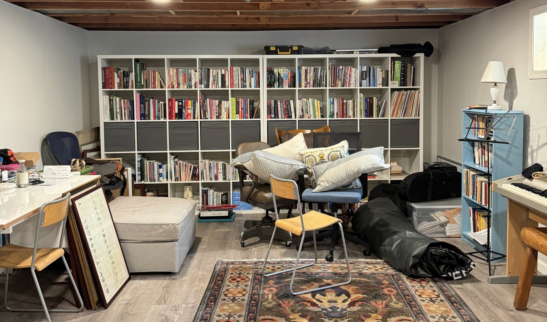 white bookcases with messy space in basement