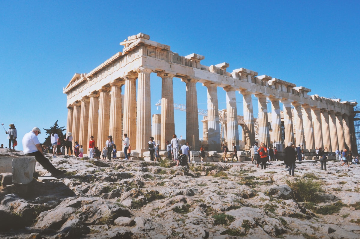 Visitors approaching the ancient Parthenon ruins on a sunny morning in Athens