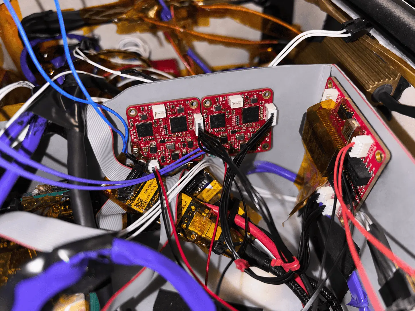 Close-up of BotBlox SPEBlox boards wired into the MIT Motorsports race car electronics