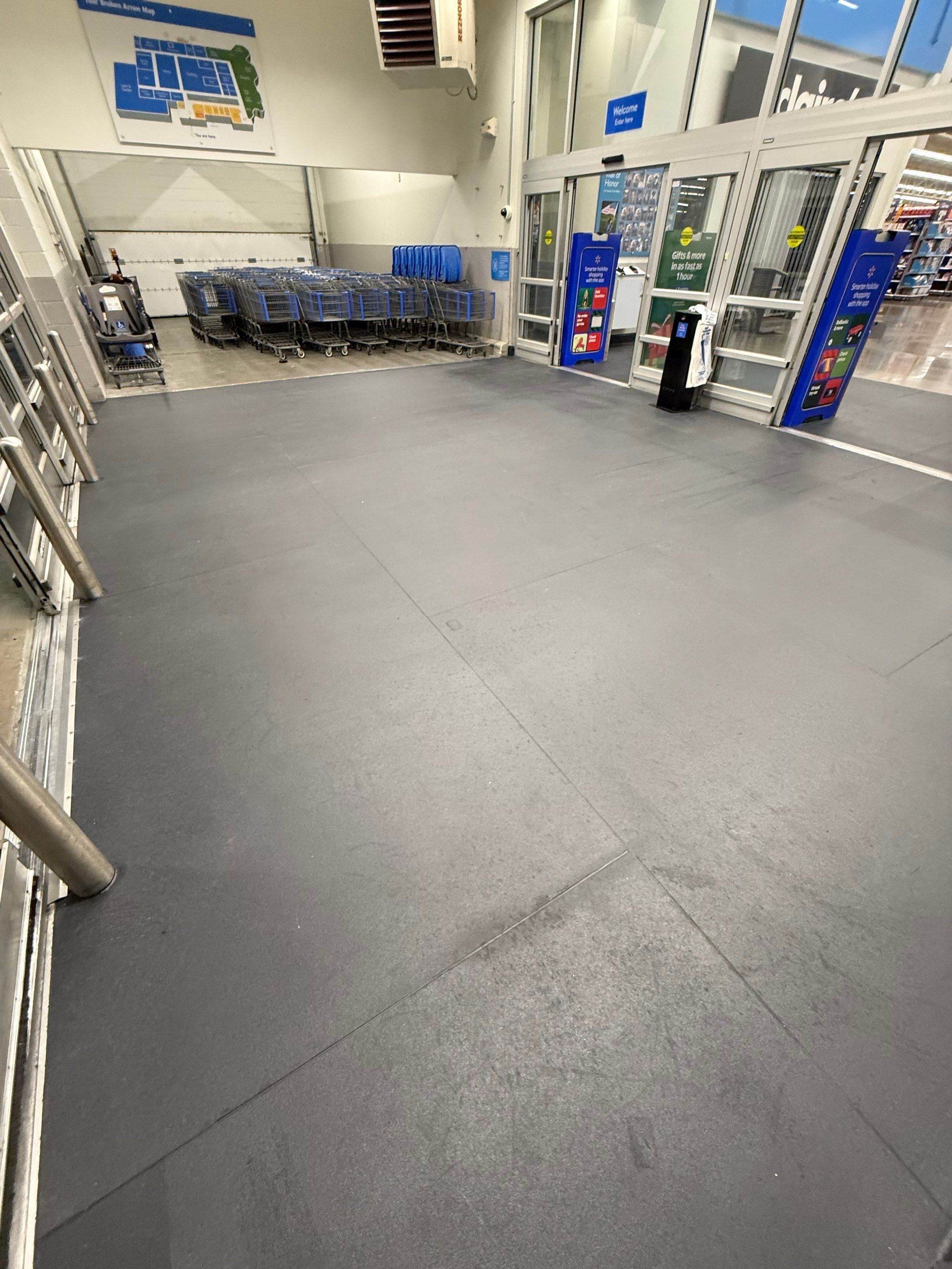 Newly installed Eco-Grip flooring inside a Walmart store entryway, providing a slip-resistant and durable surface near shopping carts.