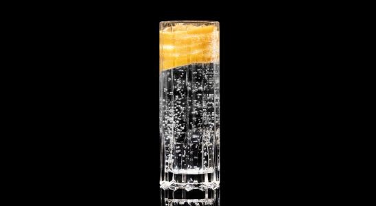 A closeup of a Sweet, Year Round The Neon Strip drink against a dark background.