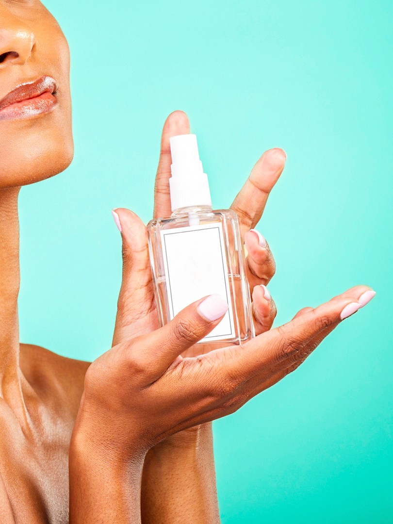 gold perfume bottle on white textile