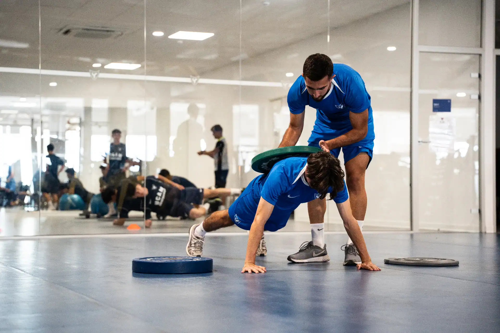 Players of the UCAM International Football Team performing strength exercises at the university gym | UCAM Catholic University of Murcia