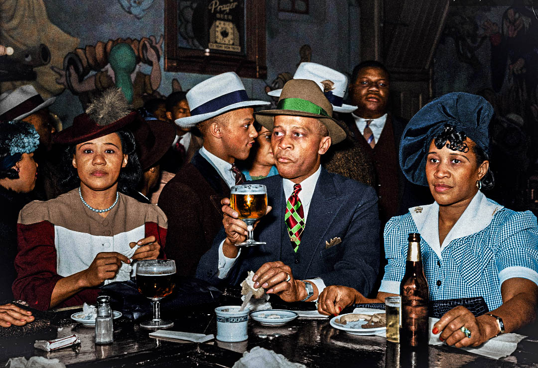 a picture of african americans sitting at a bar in great 1940 outfits.