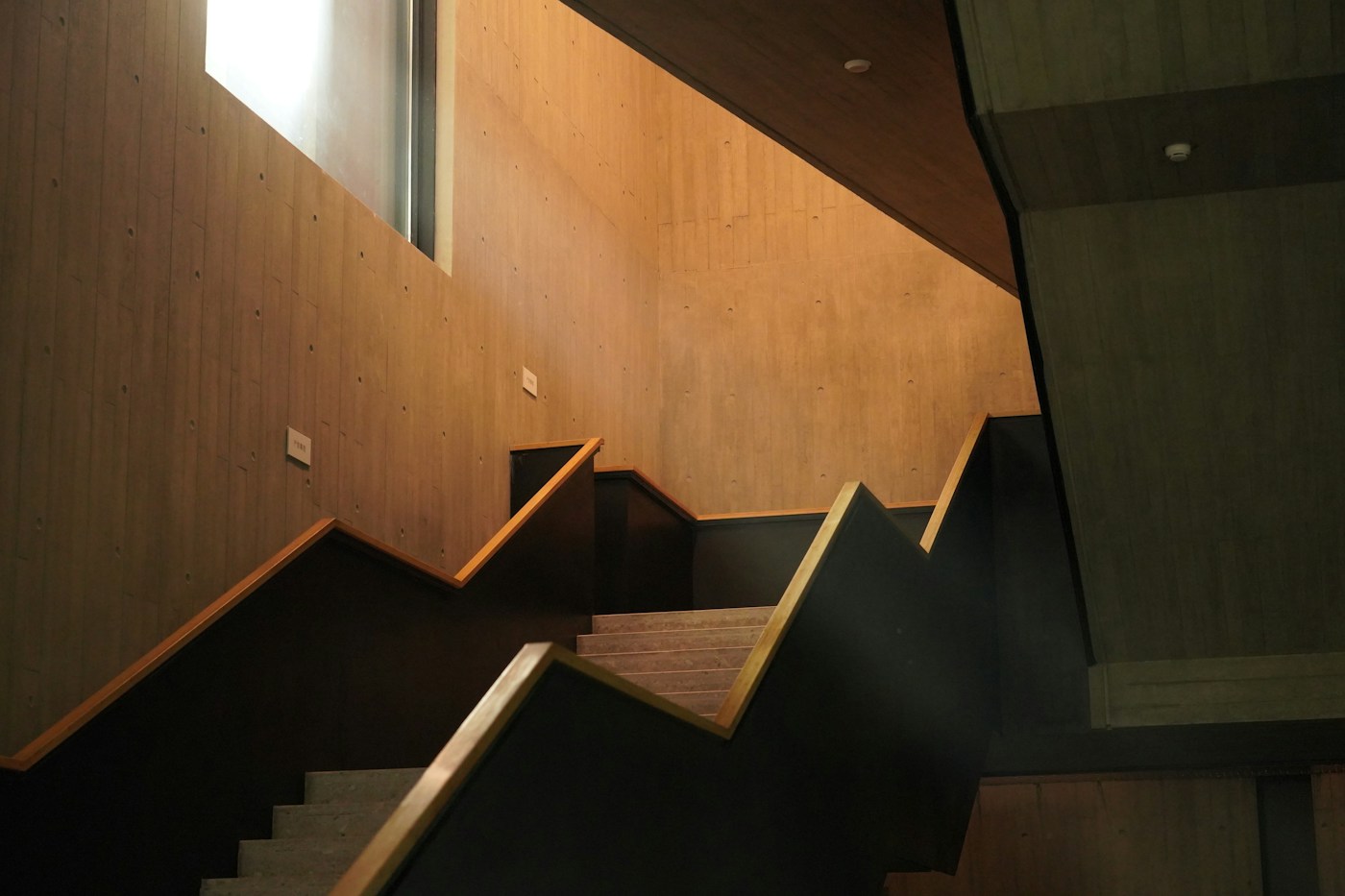 A timber stair with dark steel treads