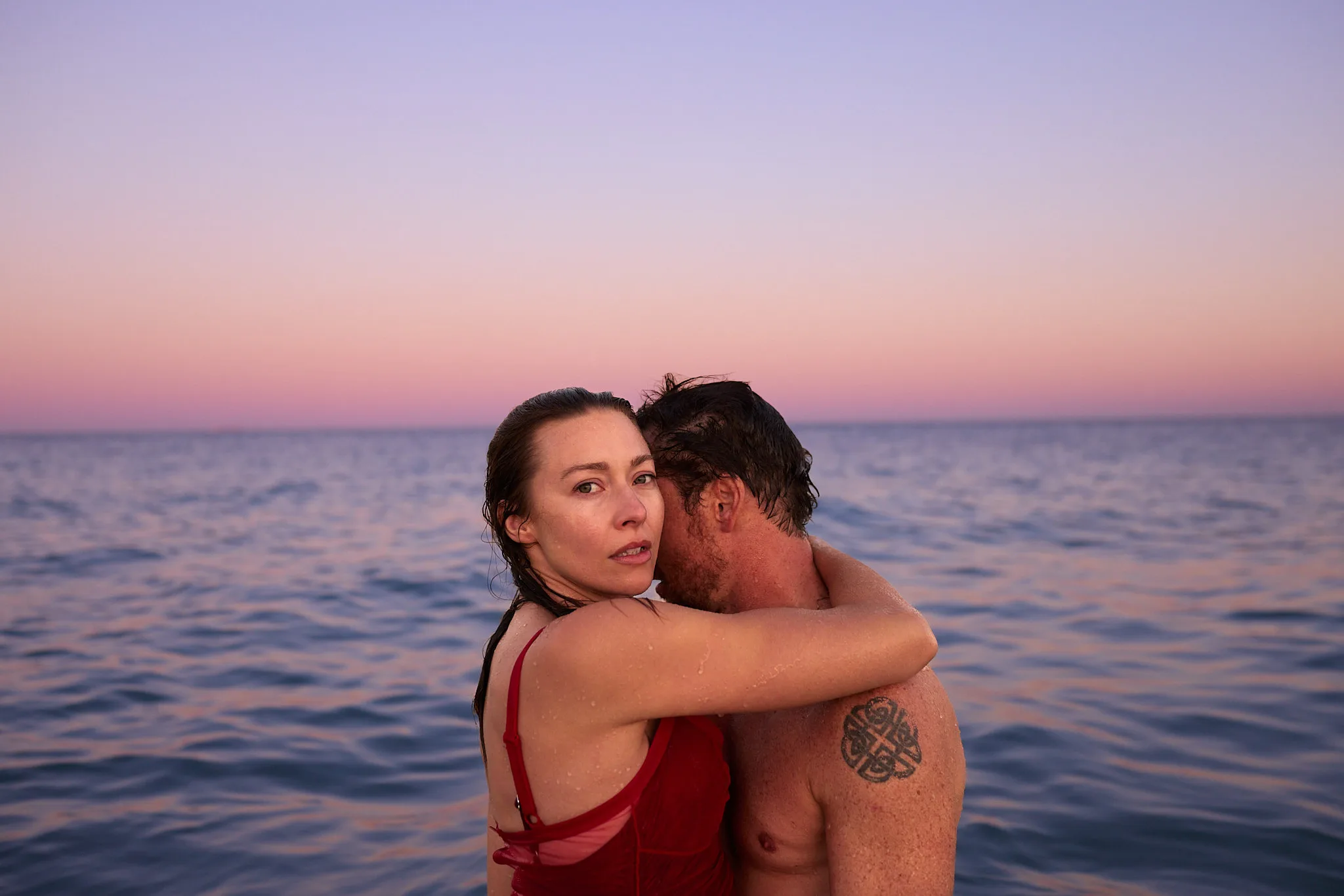 wet embrace in ocean at dusk — portrait photography by Tom Kubik