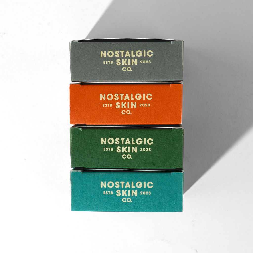 Stacked Nostalgic Skin Co. soap boxes in multiple scents