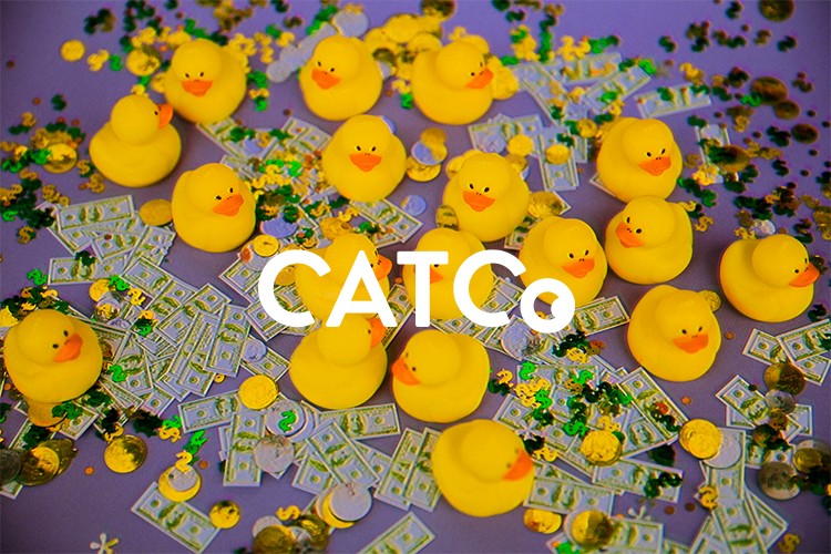 A laptop displaying the "CATCO" website, featuring a project-based interface for experimenting with art and technology, surrounded by hands reaching toward a blue surface.