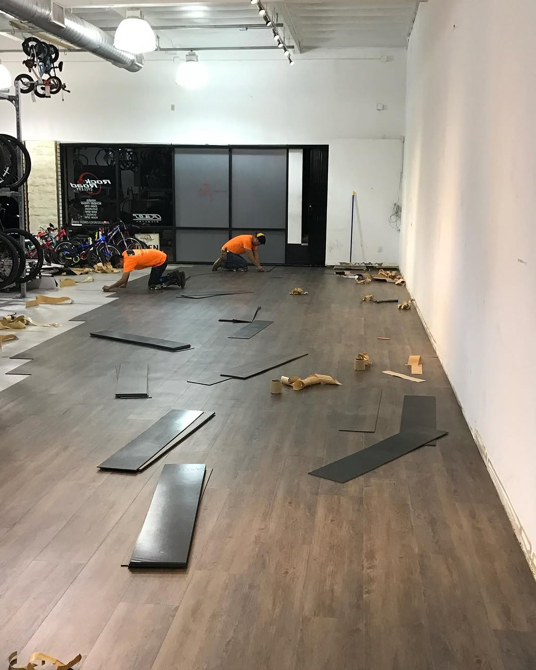 Floating LVT going down the length of a bike shop