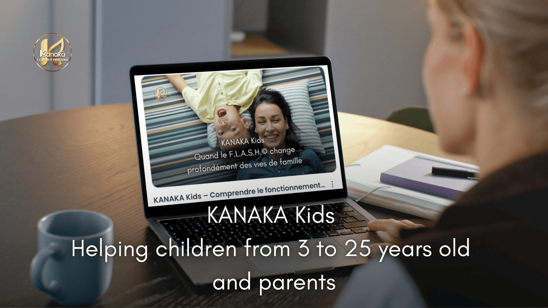 A woman at a desk views a laptop showing a joyful image of two smiling children. Text: "KANAKA Kids - Helping children from 3 to 25 years old and parents." A calm, supportive tone.