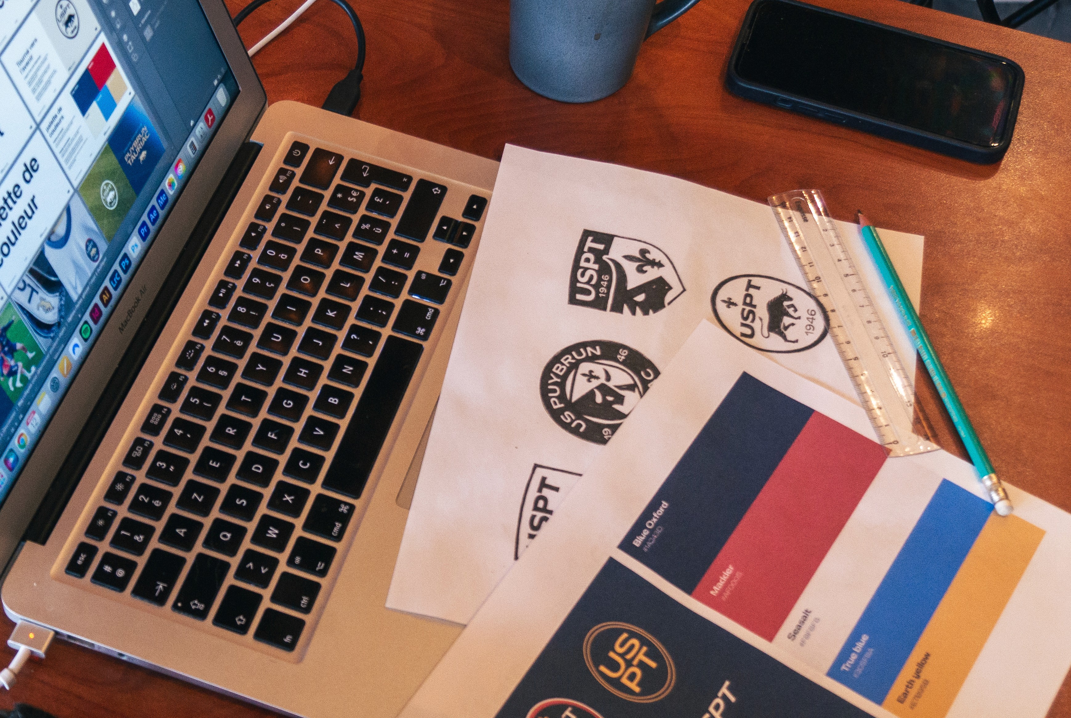 Modern home office setup with a monitor, ergonomic chair, keyboard, and indoor plants near a window with blinds.