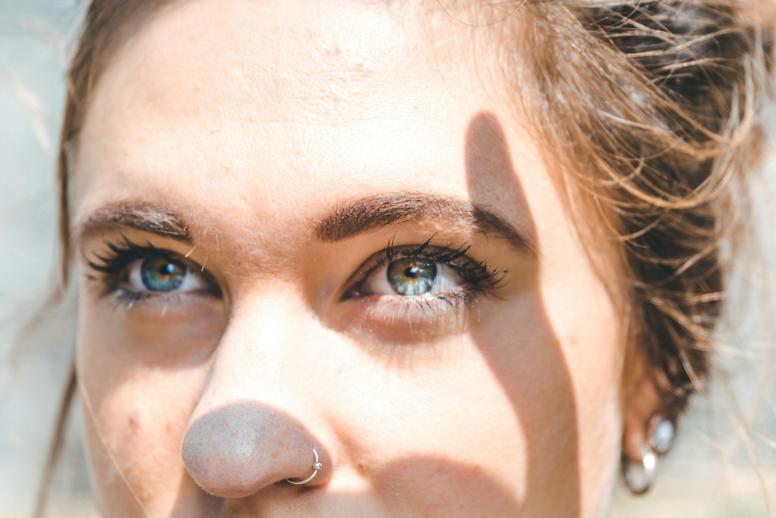 Close portrait of a woman in warm daylight, skin unretouched