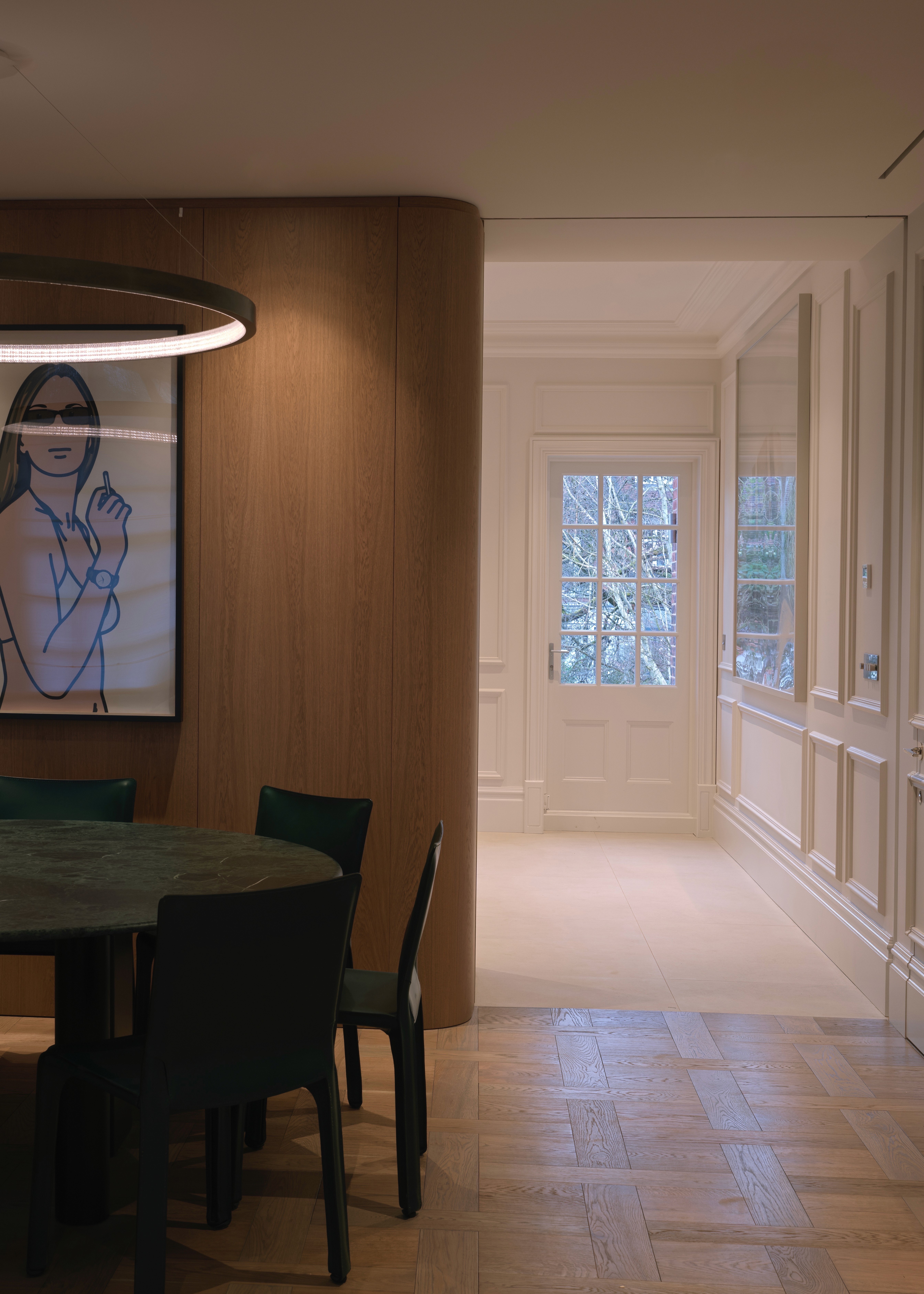 Contemporary dining space with oak wall panelling and soft natural light
