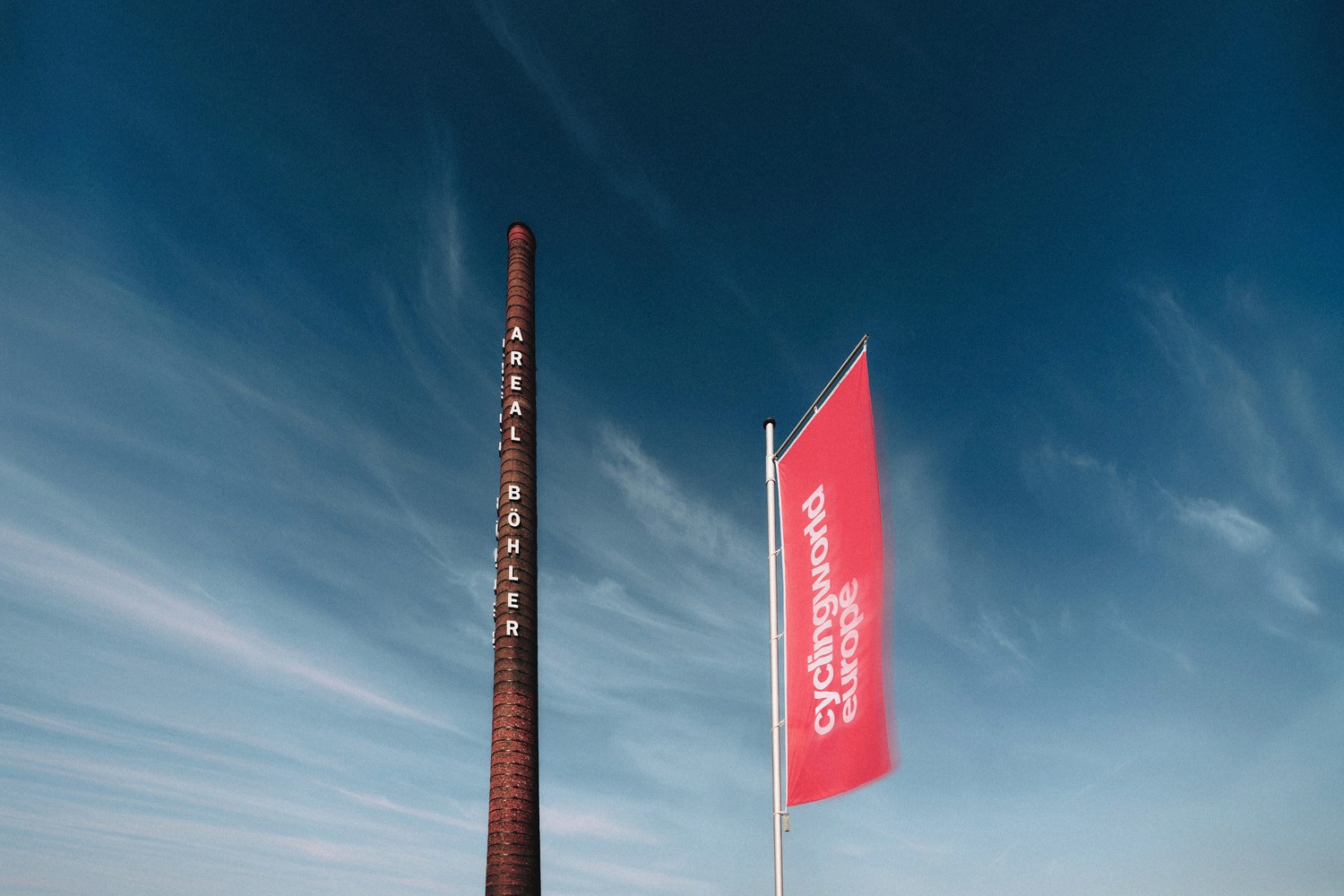 A smiling woman writing on a piece of paper in her home