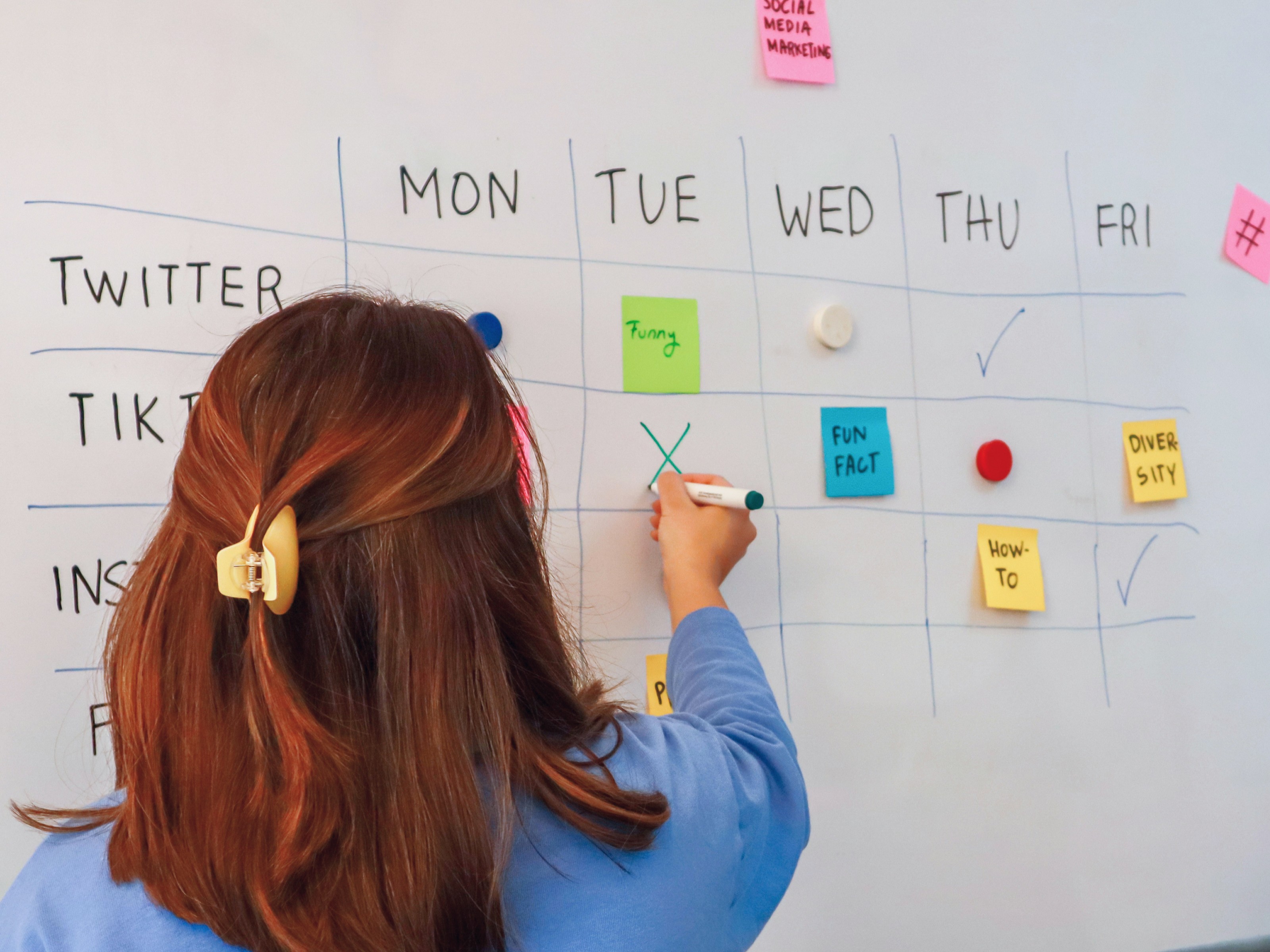 A woman filling in a content calendar