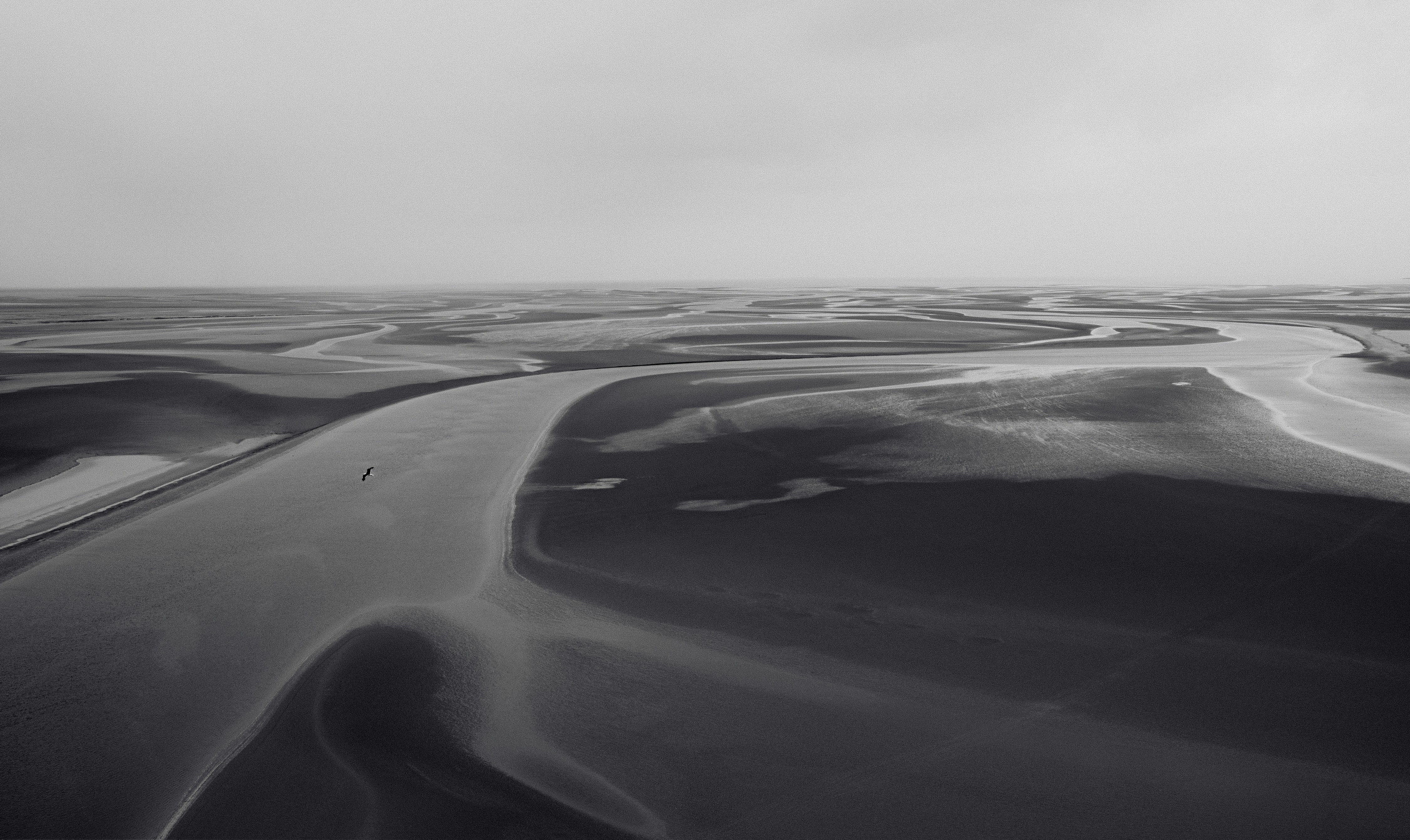 Vast sand dunes under a cloudy sky