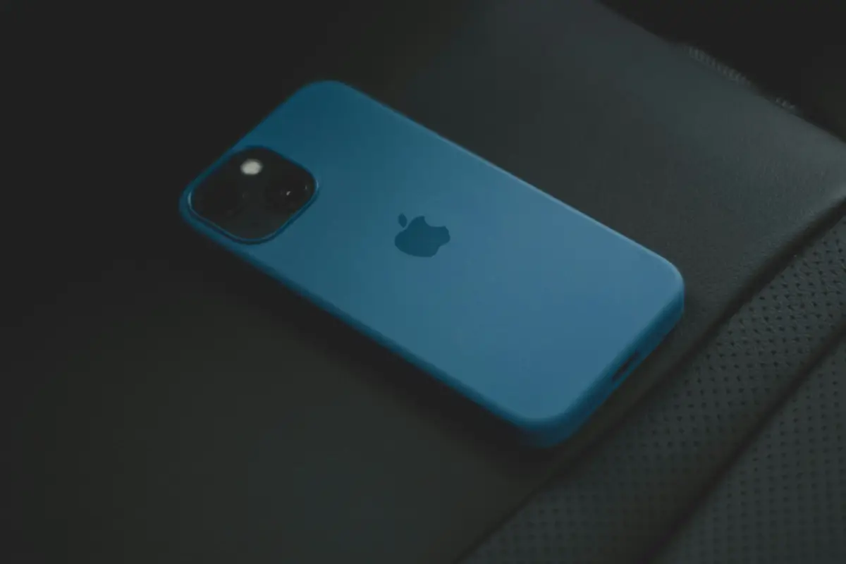 Blue iPhone on dark leather surface