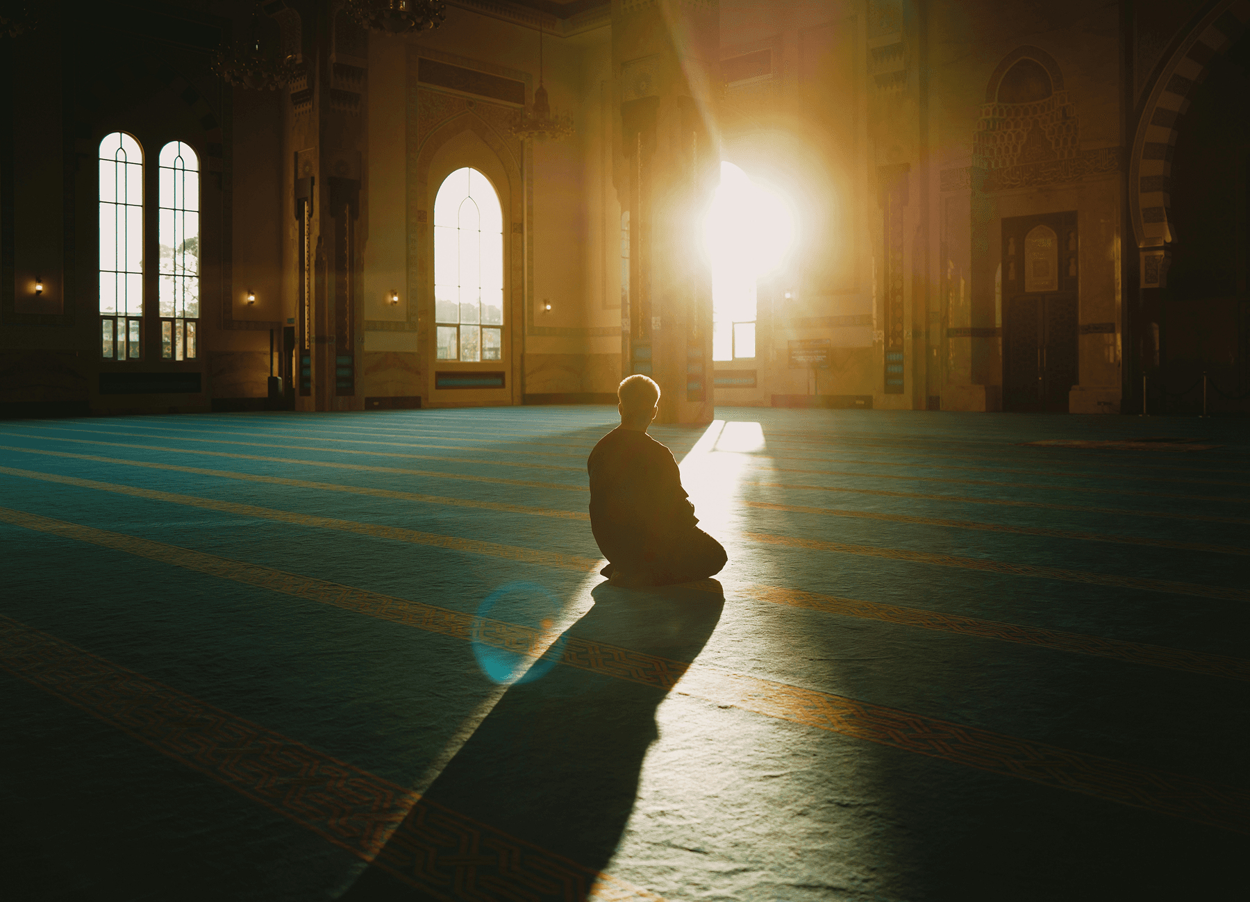 Person meditating in open room.