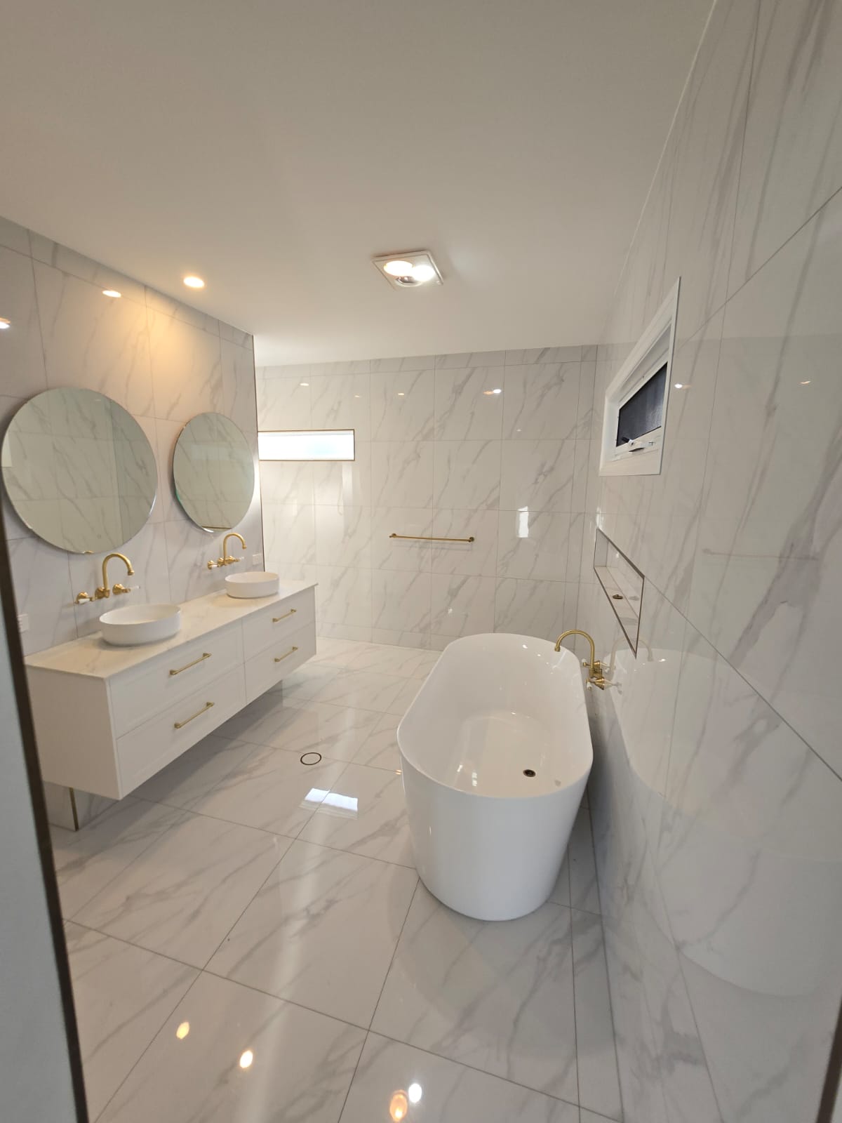 Greenfield Family Home bathroom with freestanding bath and double vanity