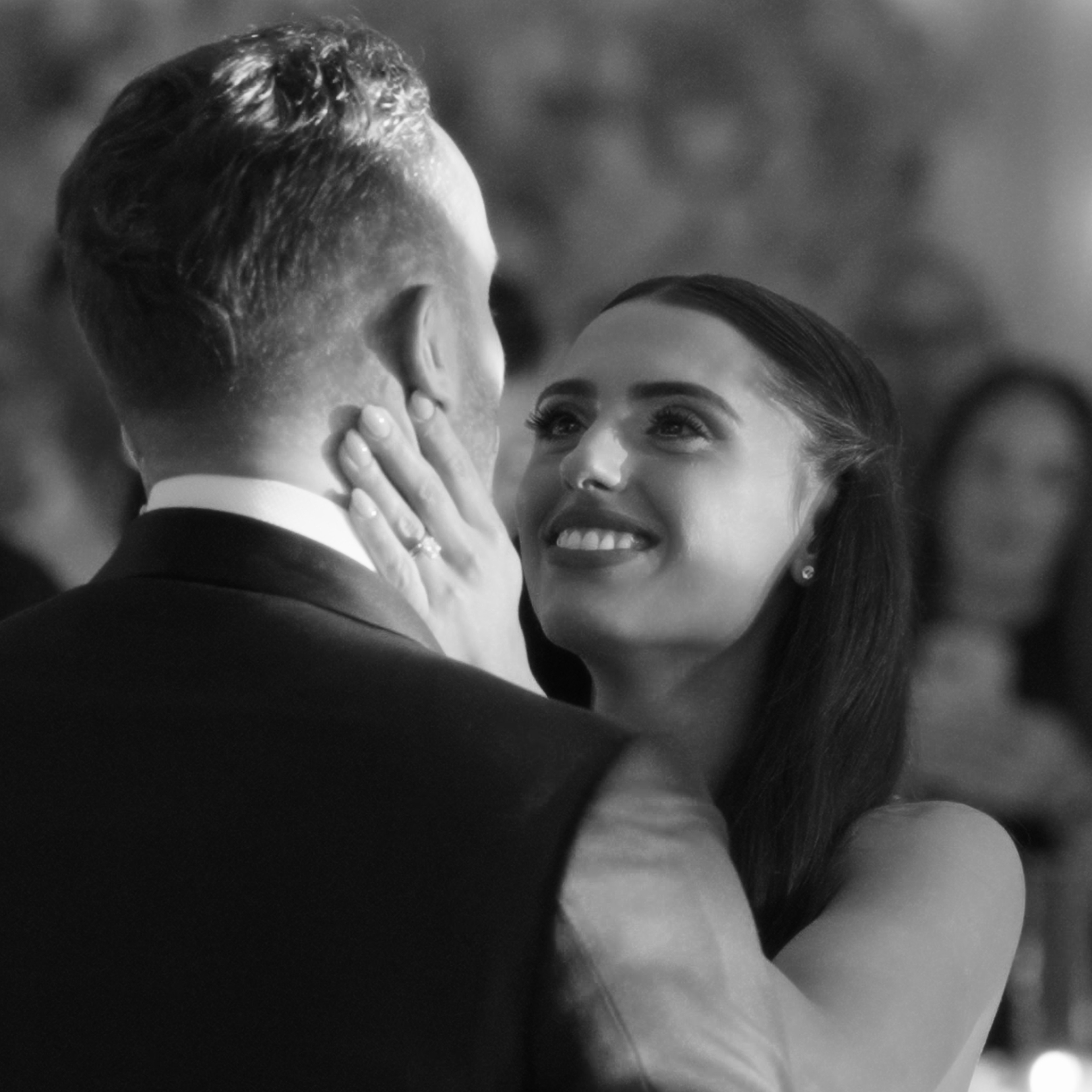 man holding gold ring on woman's finger