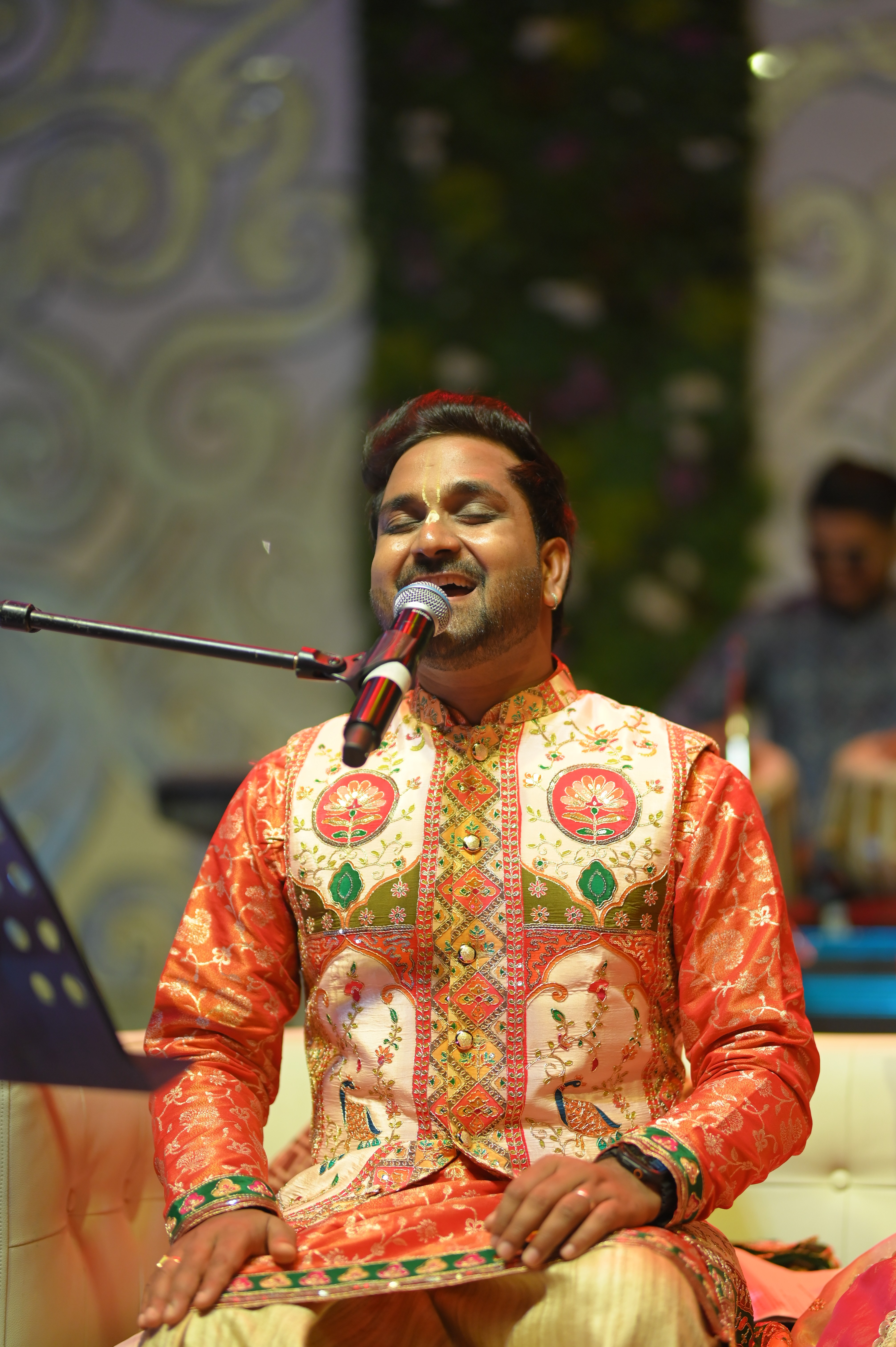 Performer under spotlight on dark stage