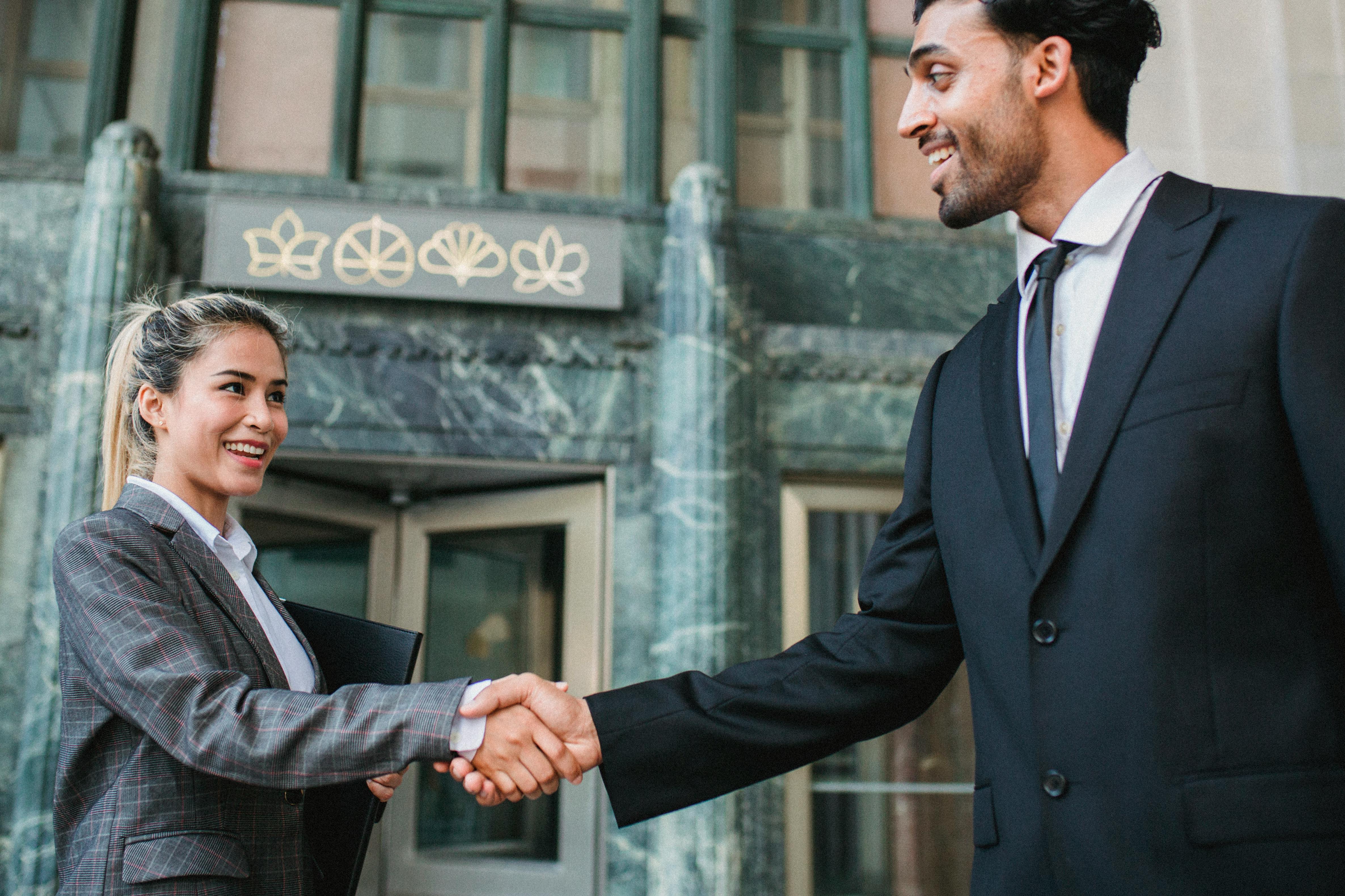 Man shaking hands with an agent after receiving mortgage bank approval