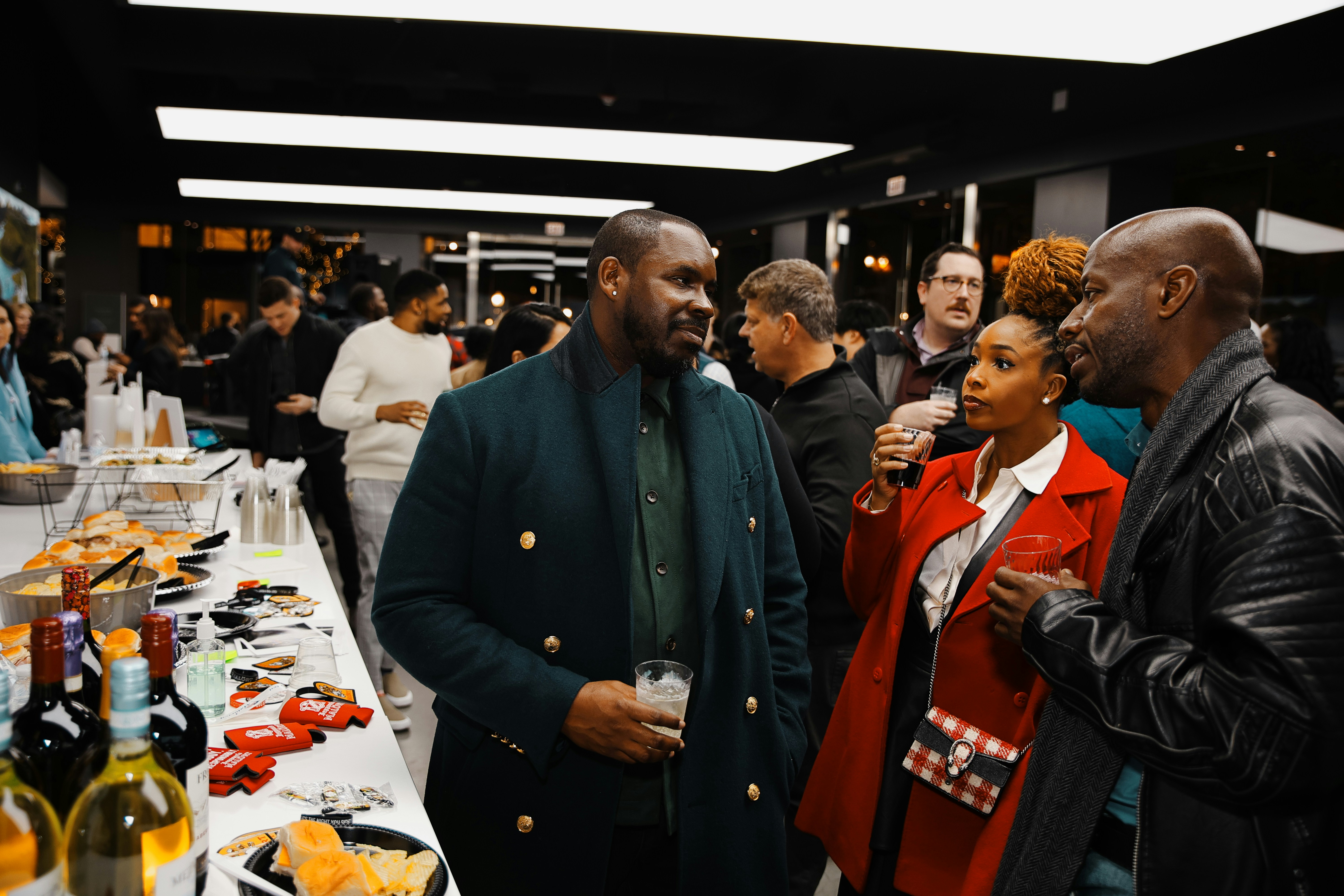 A group of people standing around a table